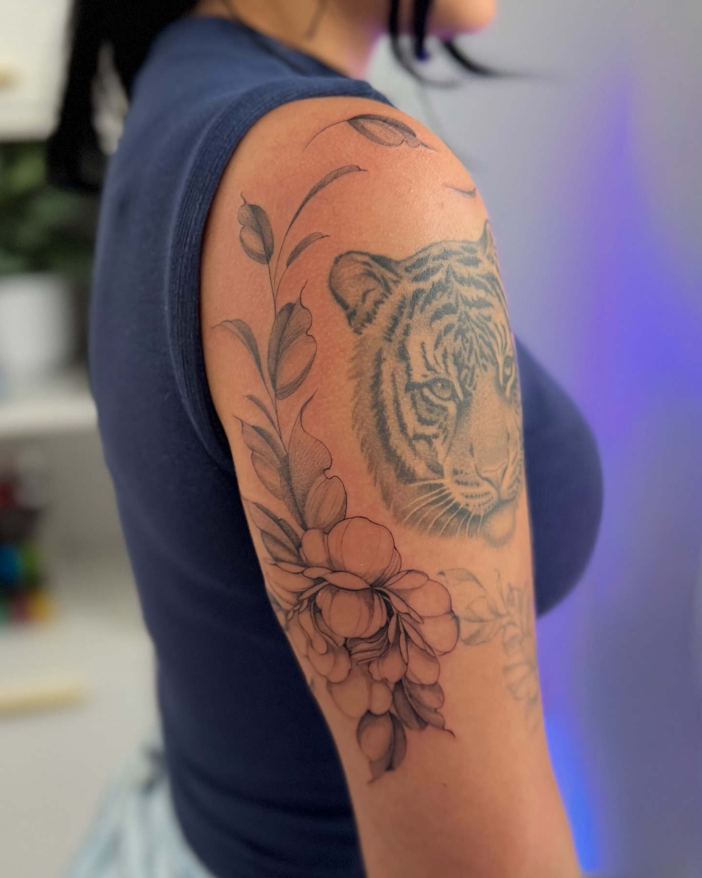 Tiger and flowers realism tattoo on the upper arm by Daniel Montoya, Charlotte, North Carolina