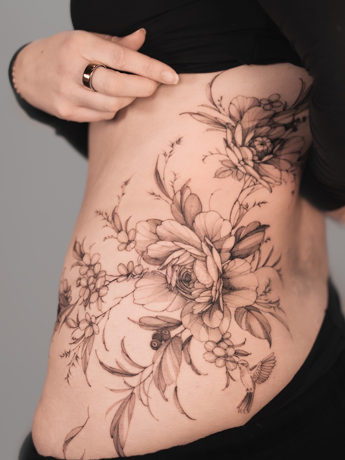 Floral bouquet black and grey tattoo on the ribs by Yuliia Babych tattoo AUSTIN