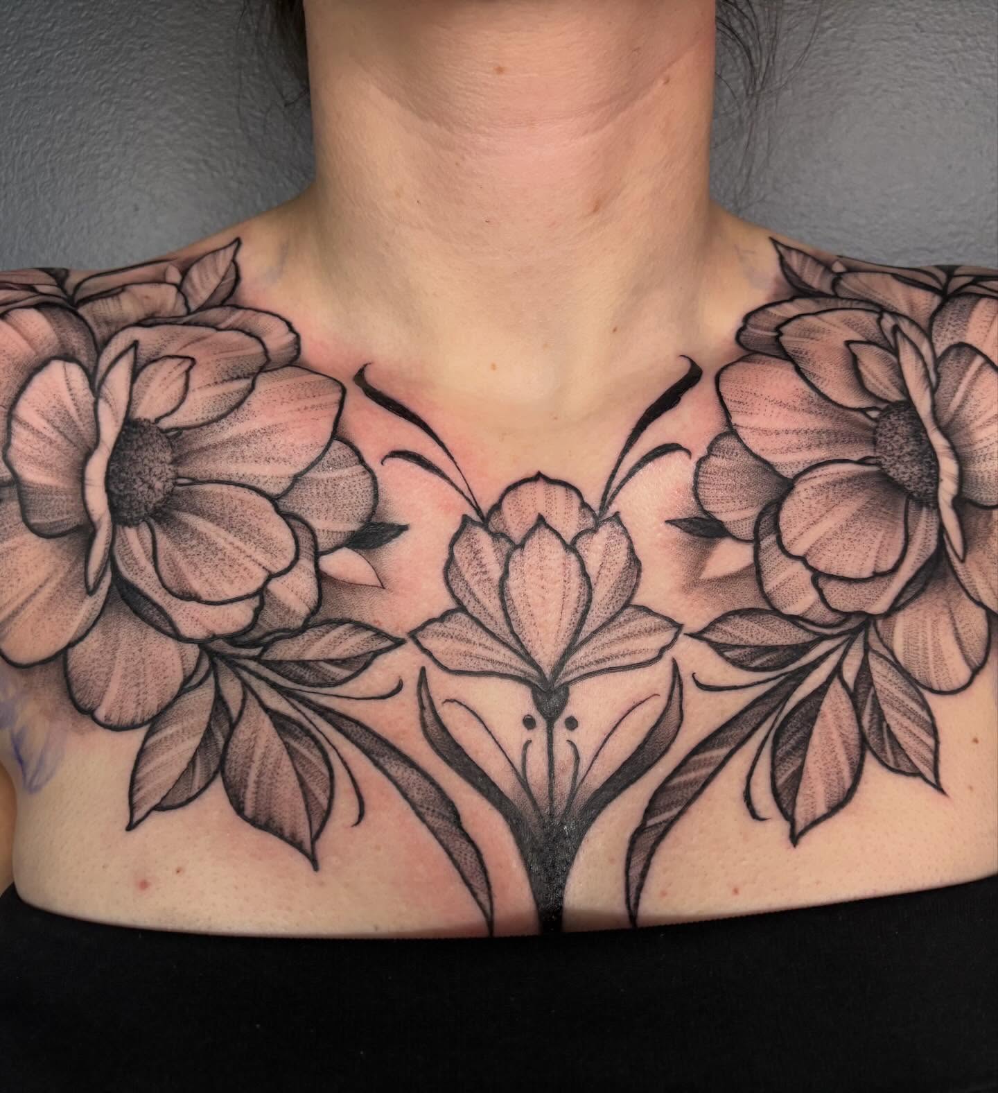 Floral arrangement black and grey tattoo on the chest by Kyle Ketzler