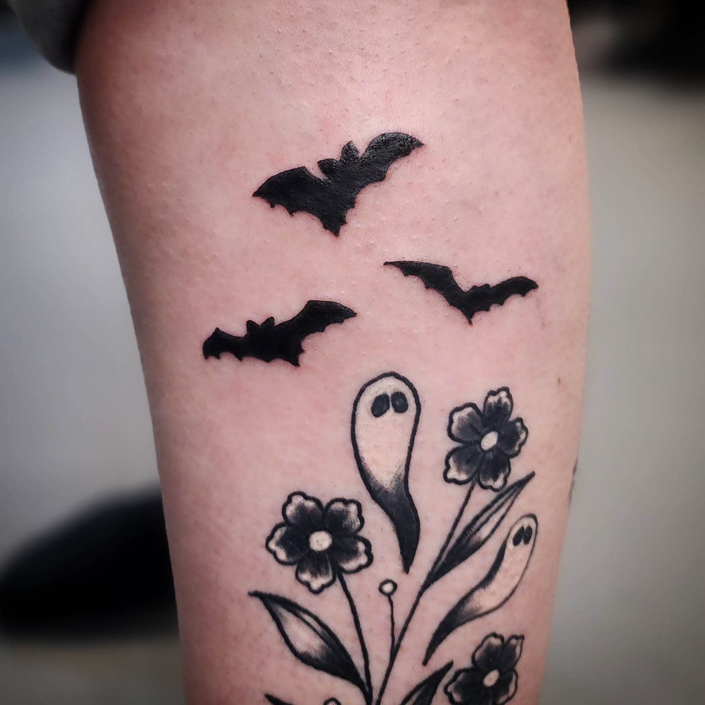 Ghost and bats black and grey tattoo on the forearm by Anntonietta Borzacchiello