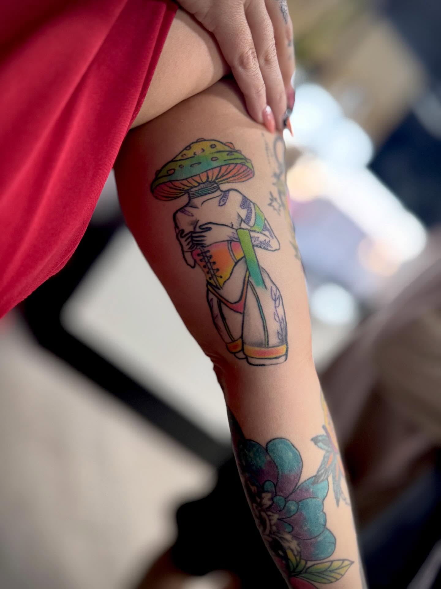 Mushroom and woman illustrative tattoo on the forearm by Katelyn Arnold