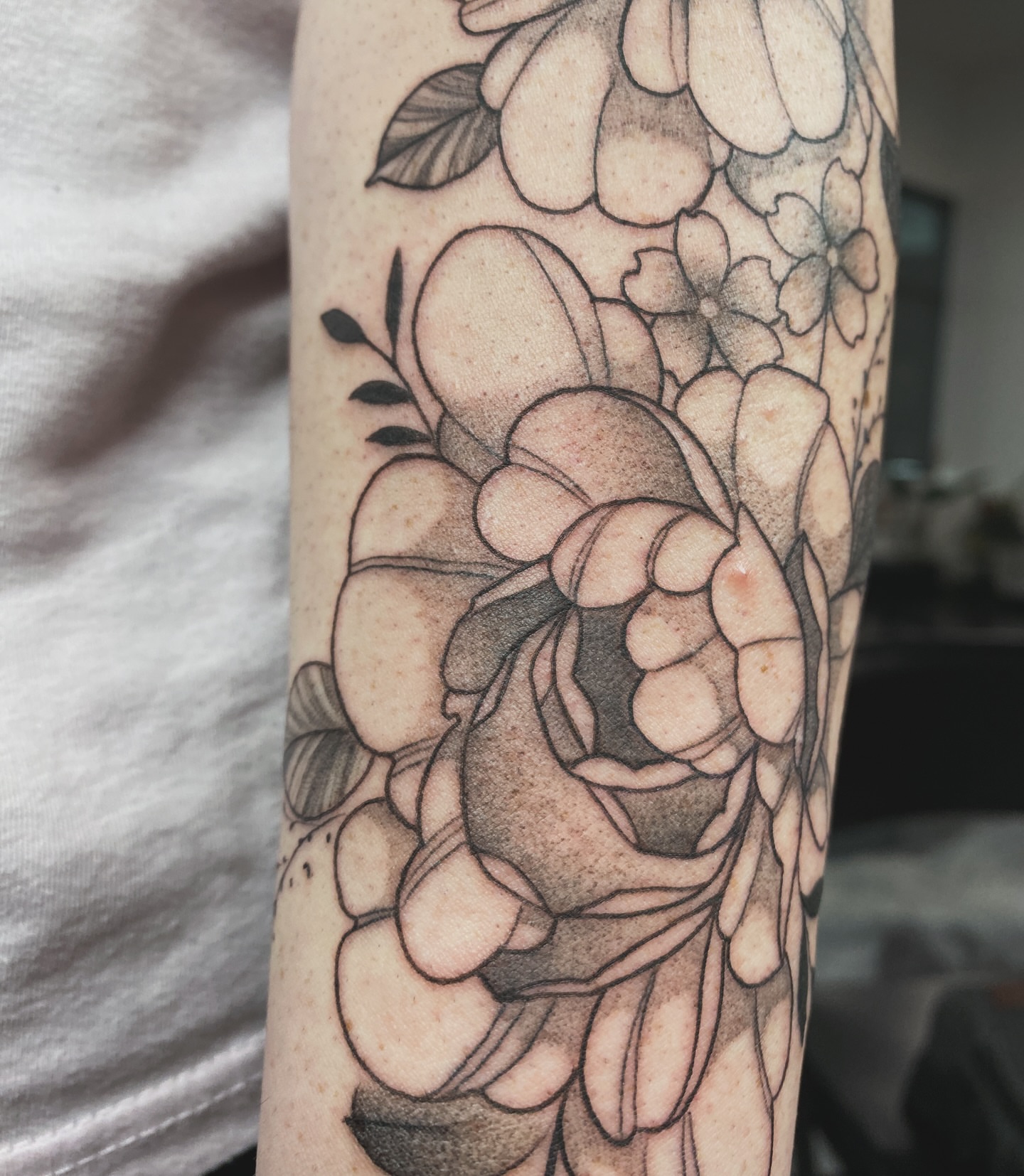 Floral bouquet black and grey tattoo on the forearm by Nikole