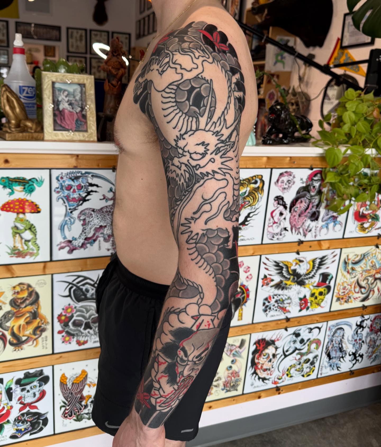 Dragon American traditional tattoo on the upper arm by Jason Eisenberg