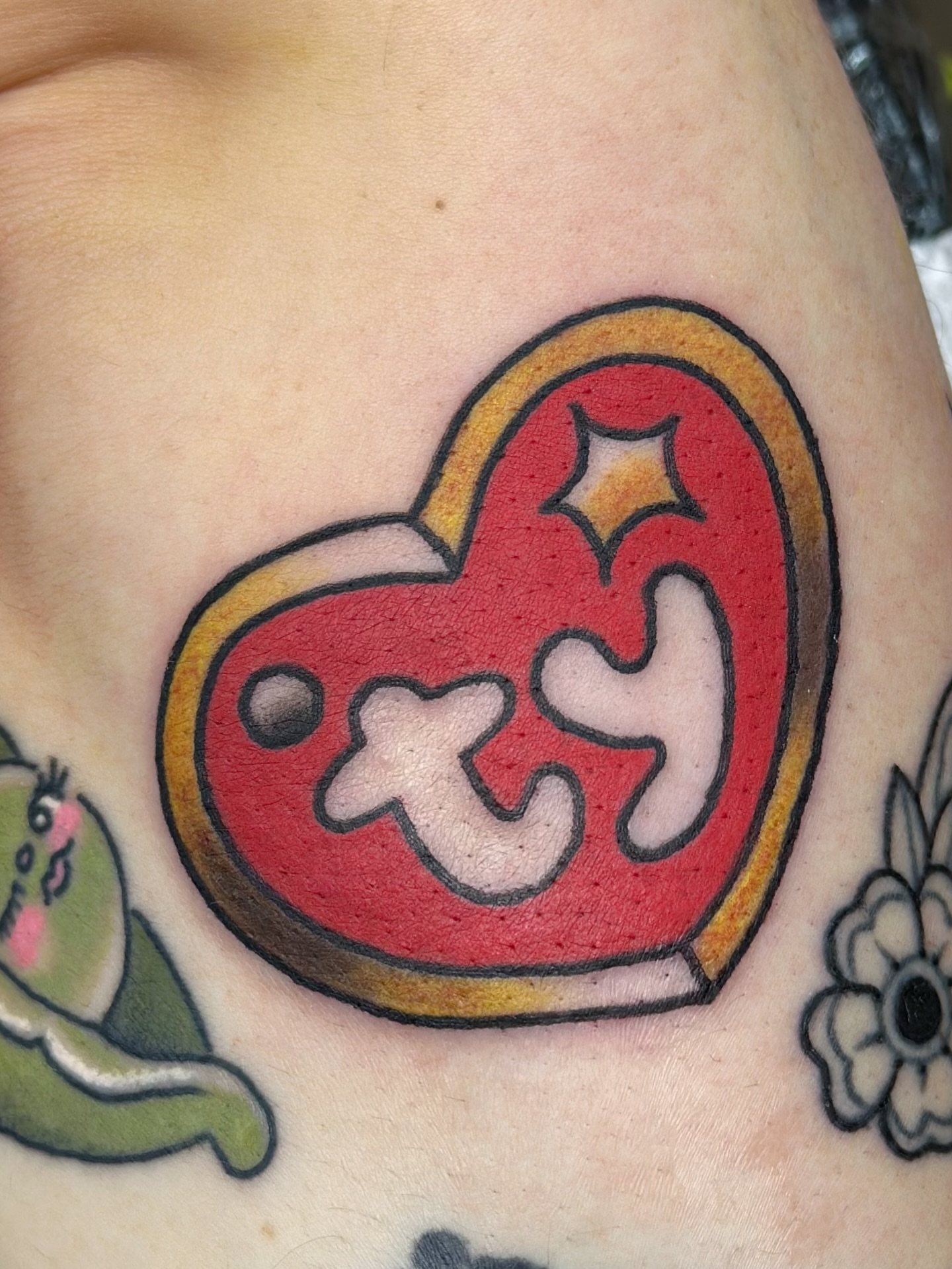 Heart with puzzle piece dotwork tattoo on the chest by Lucy Jay