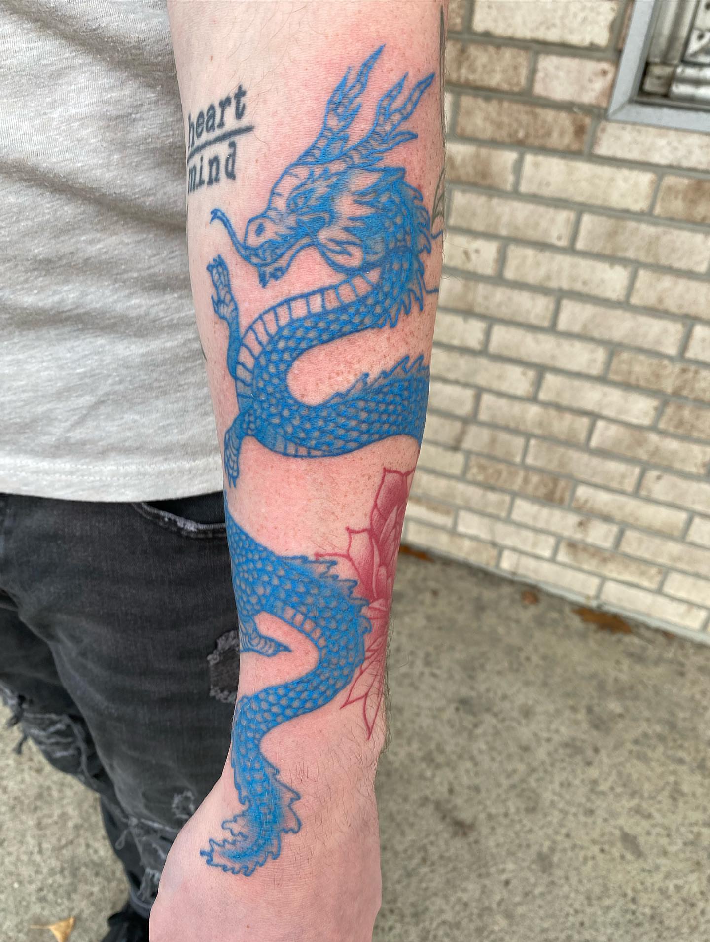 Blue dragon dotwork tattoo on the forearm by Savanna Starr Mortensen