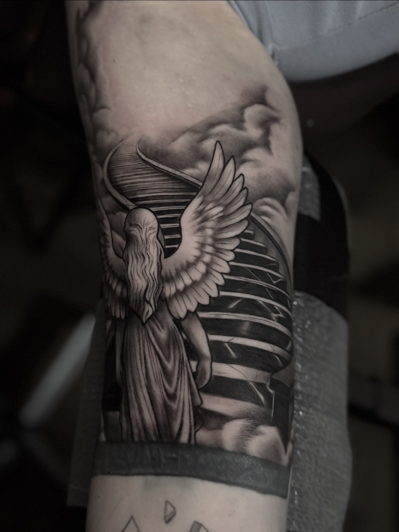 Statue with wings realism tattoo on the forearm by Jaxx Kesler