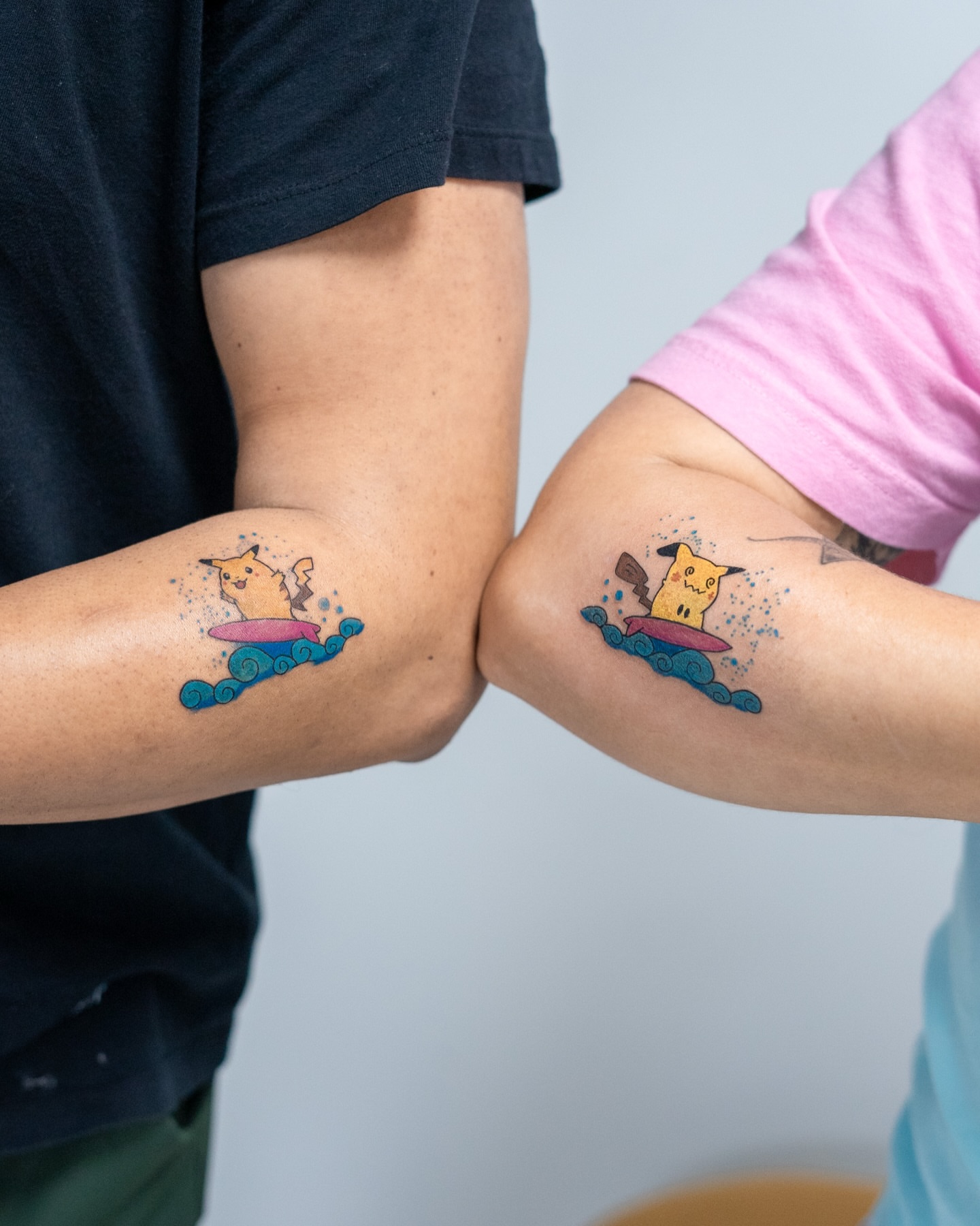Surfing Pikachu new school tattoo on the forearm by The Tattoo Plug