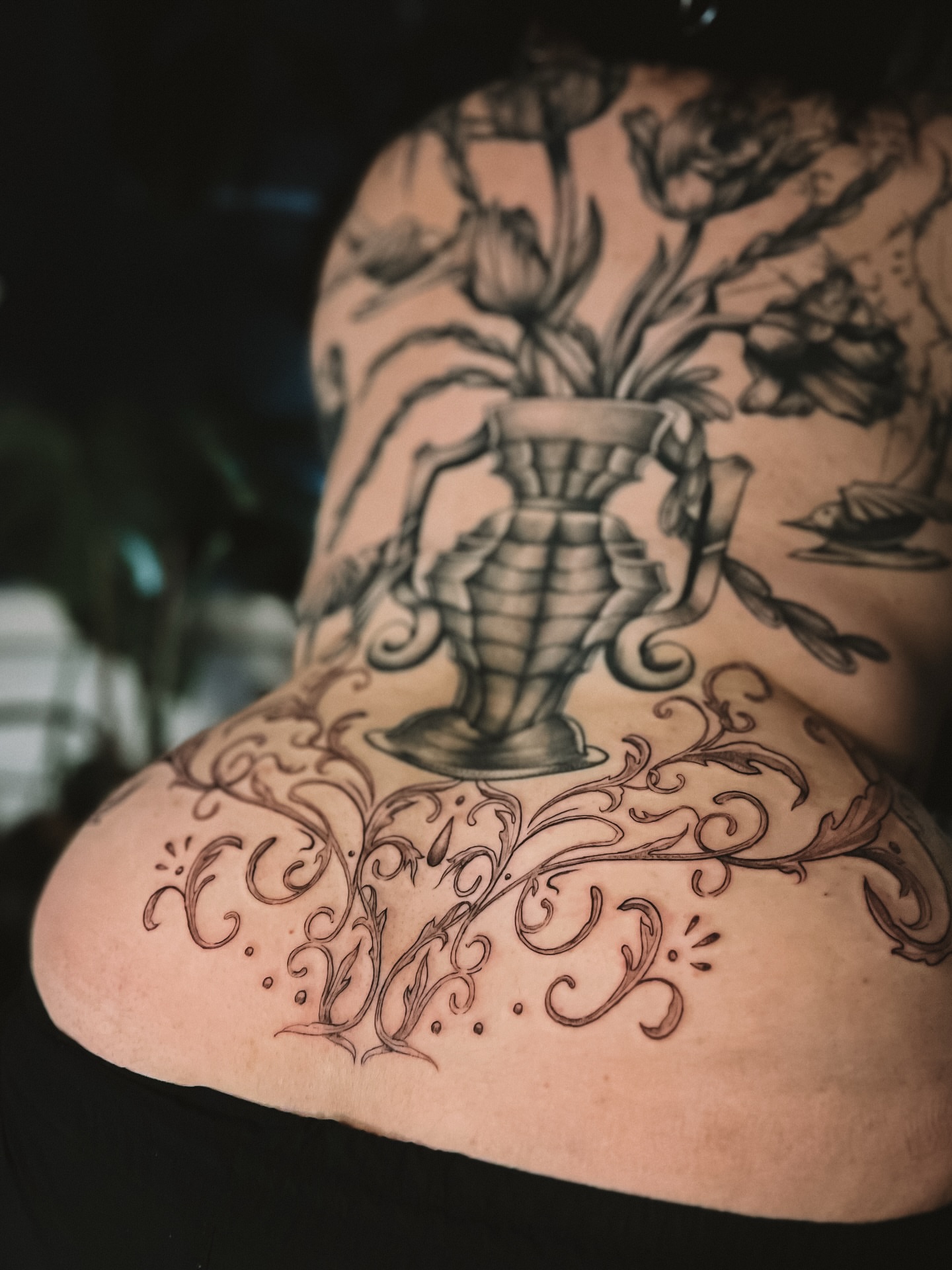 Vase with flowers black and grey tattoo on the back by sebs phạm, Los Angeles, California