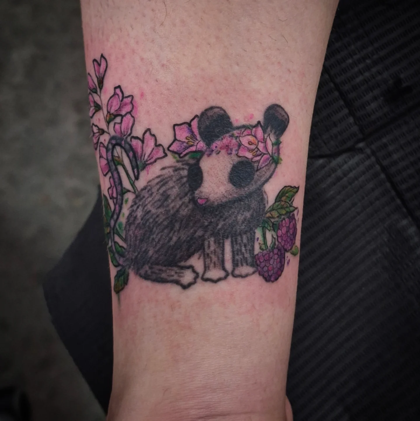 Panda with flowers new school tattoo on the forearm by Lydia Kiley