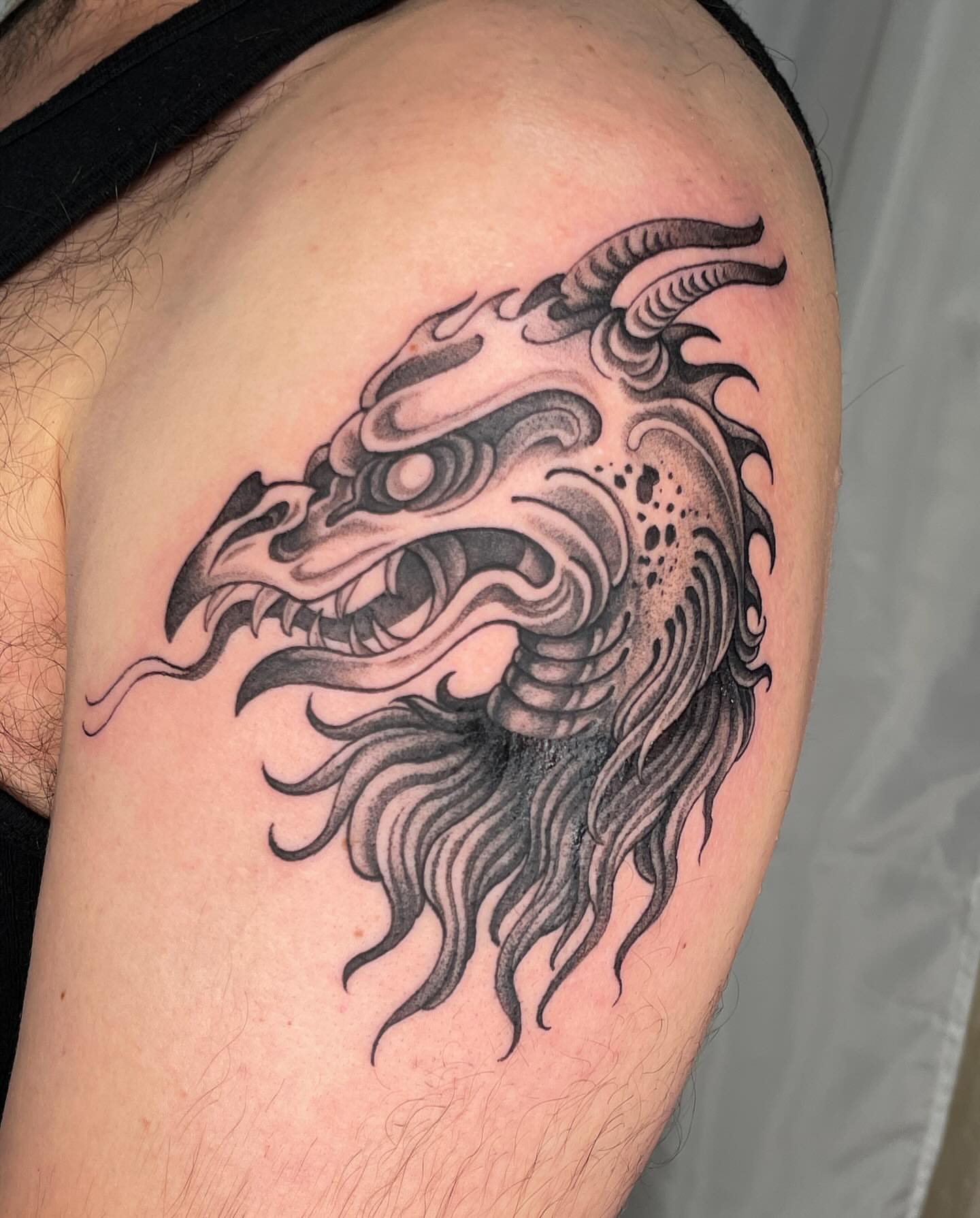 Dragon head black and grey tattoo on the shoulder by 𝖂𝖍𝖆𝖙𝕽𝖊𝖎𝖑𝖊𝖞