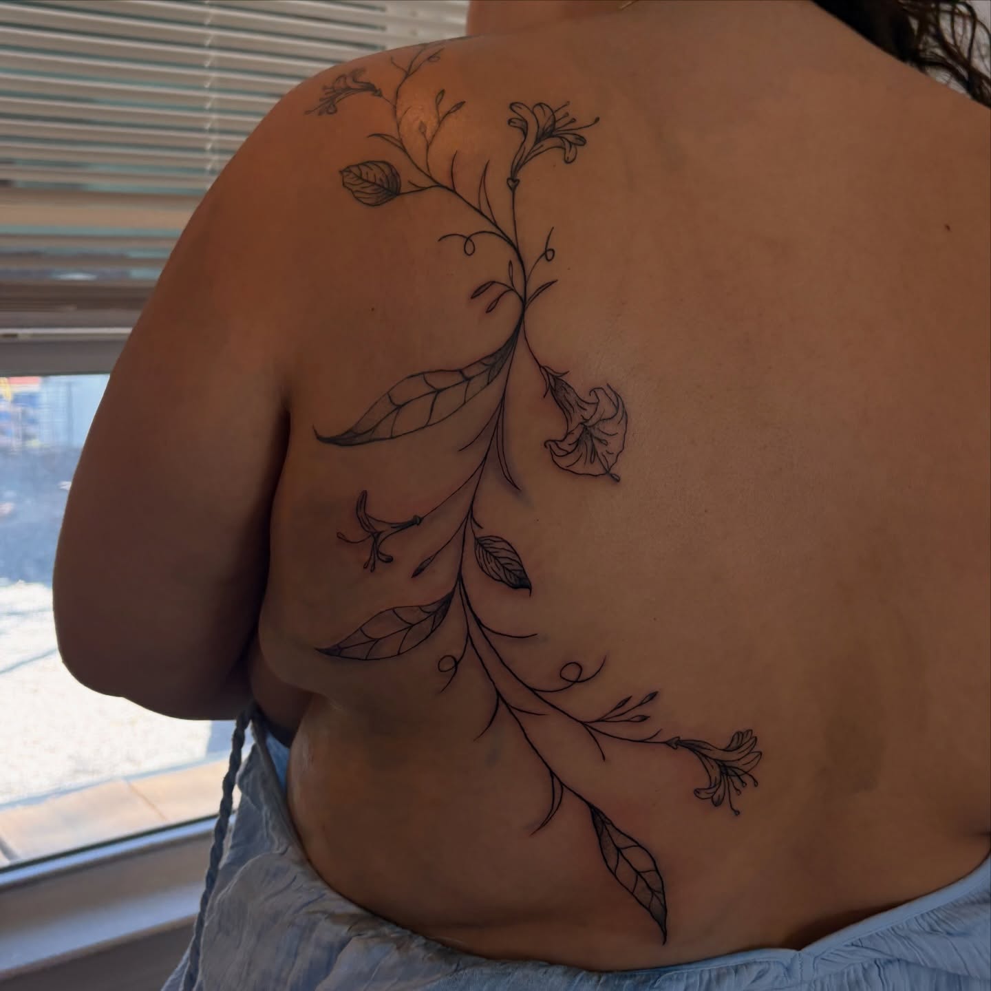 Floral vine fine line tattoo on the back by Emma🌸✨Austin Tattoo Artist