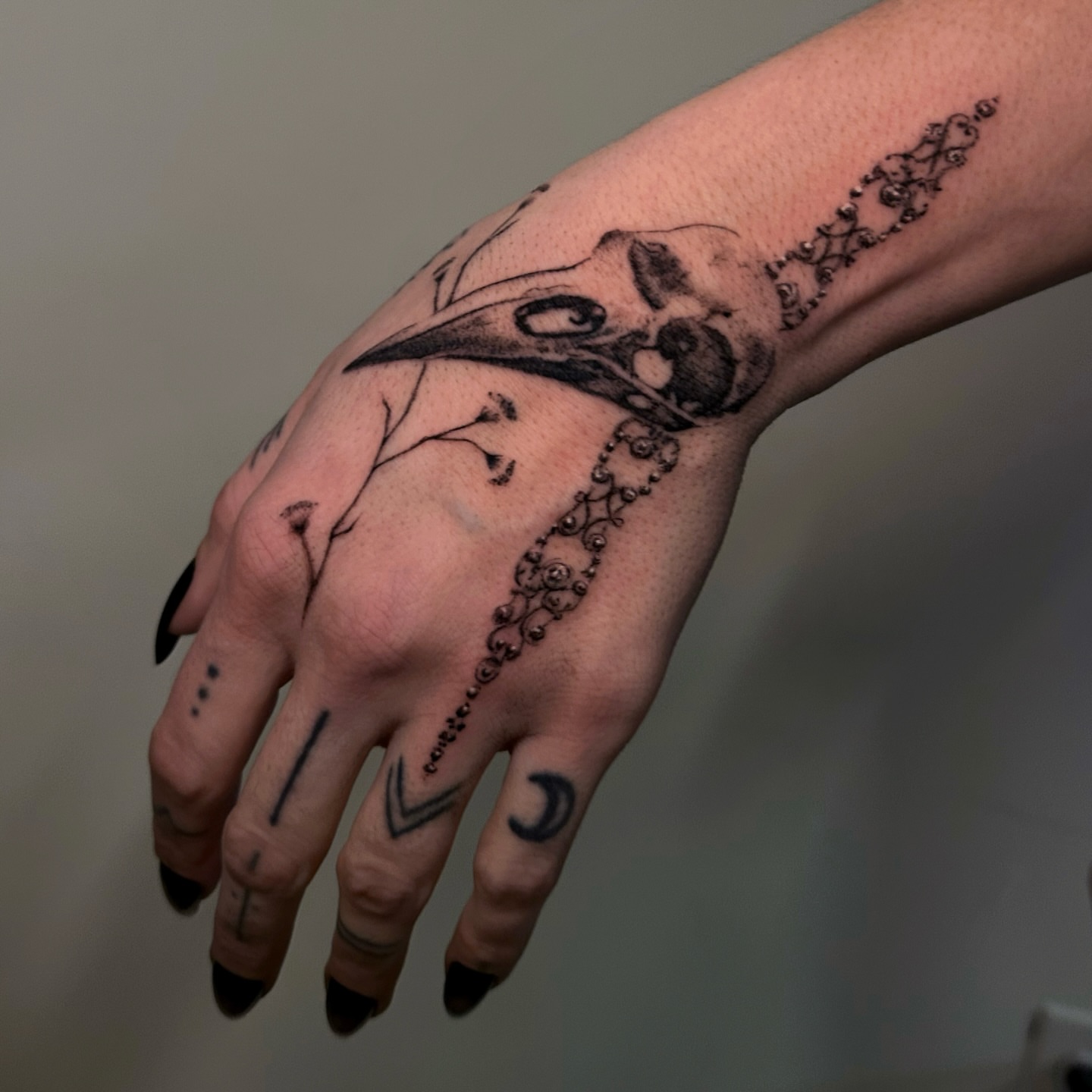 Skull and crow dotwork tattoo on the hand by kale