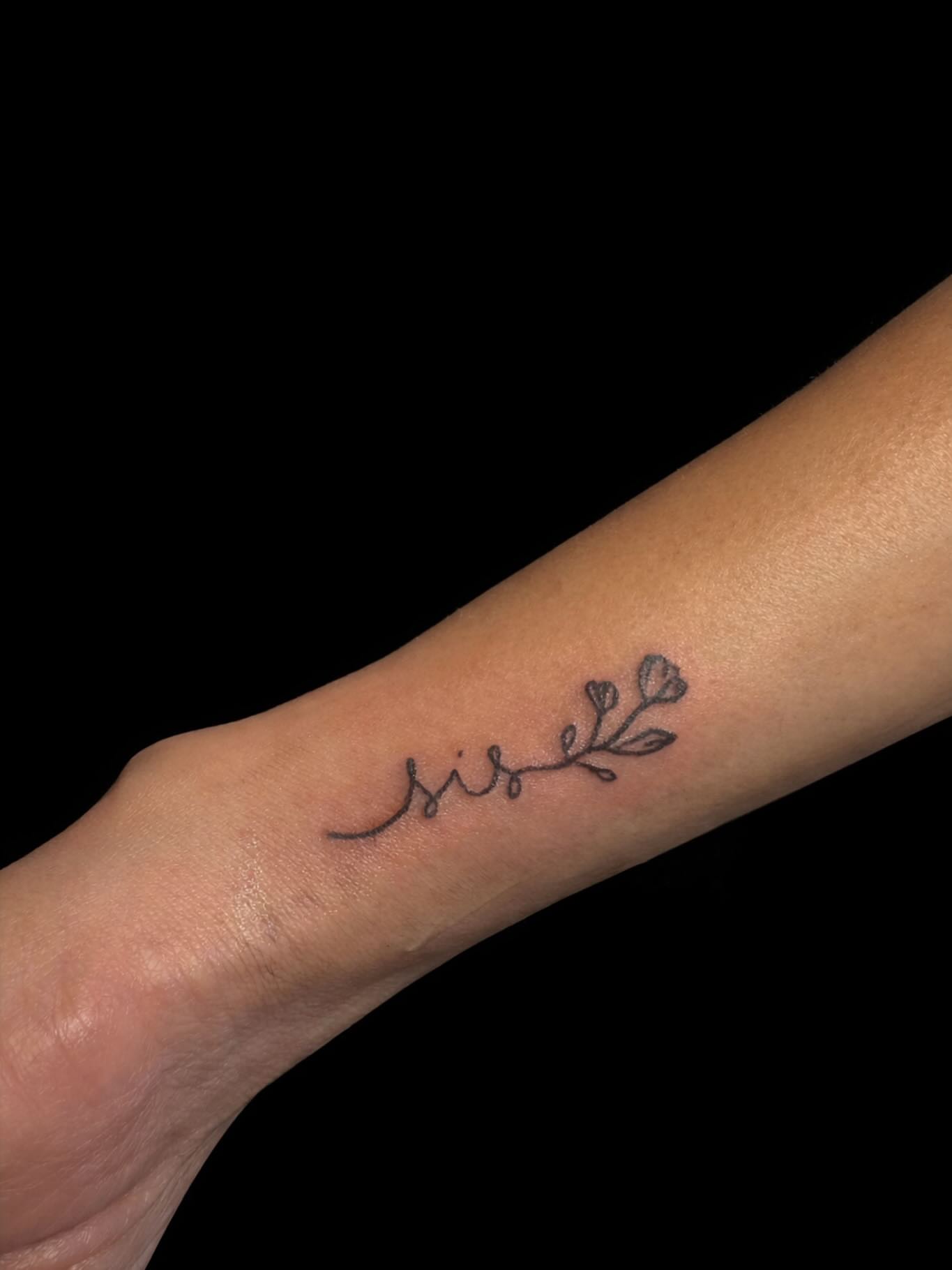 Flower branch fine line tattoo on the forearm by Victoria Cooper