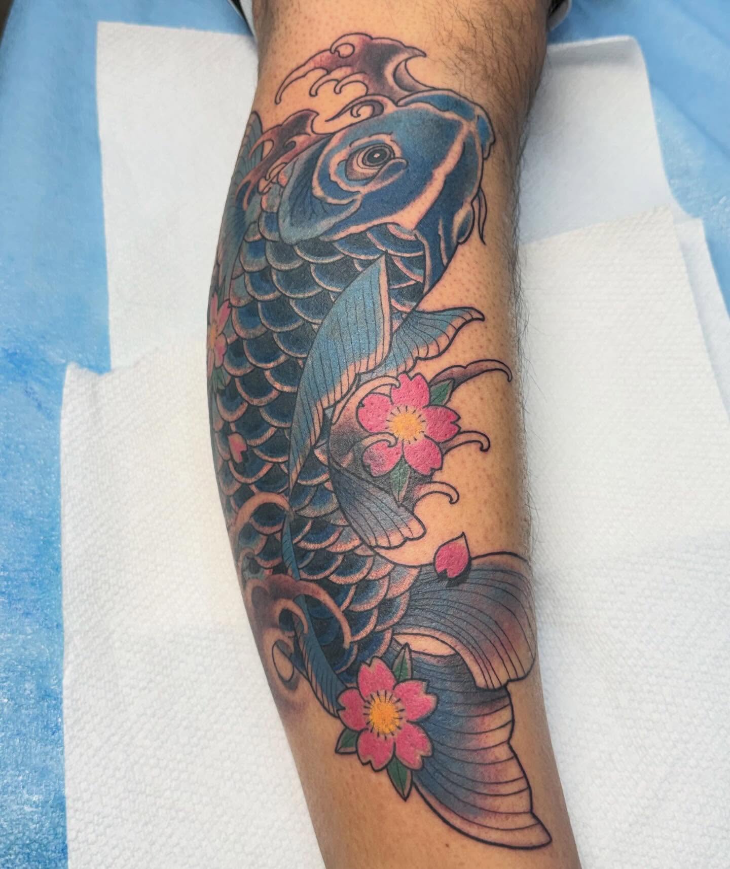 Koi fish and flowers japanese irezumi tattoo on the forearm by Eli