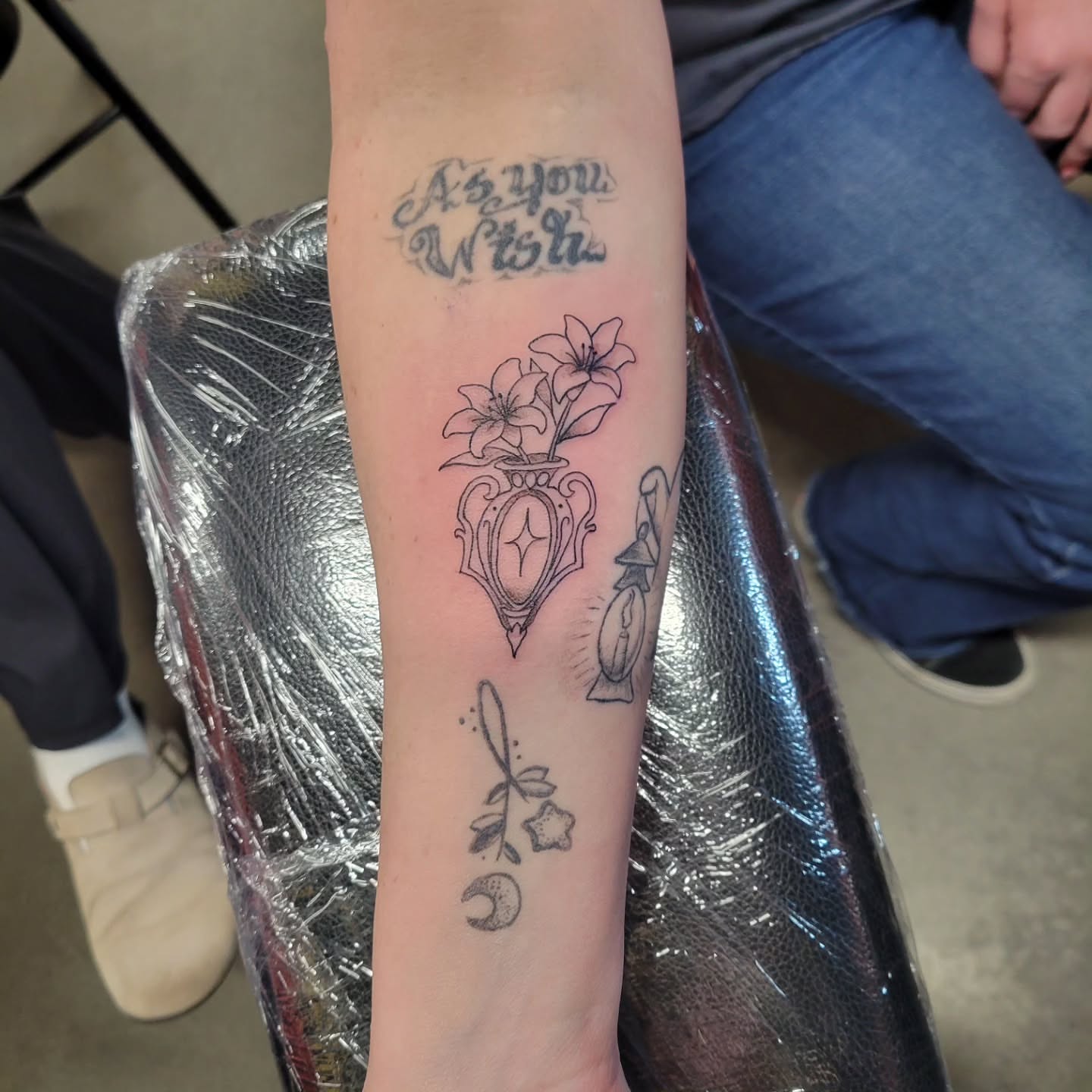 Flowers and clock black and grey tattoo on the forearm by Aspen C