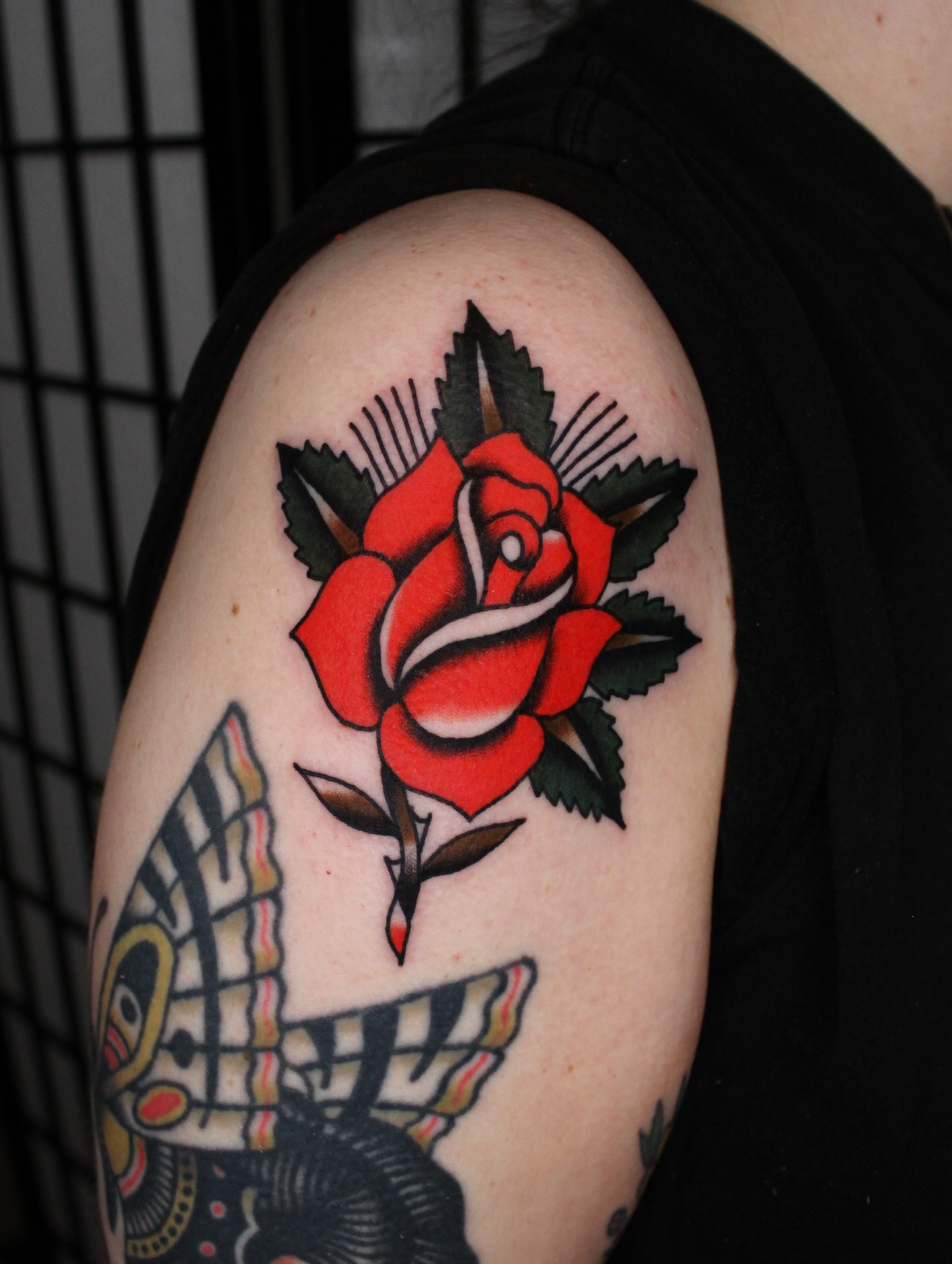 Red rose American traditional tattoo on the shoulder by Dustin Stemen, Charlotte, North Carolina