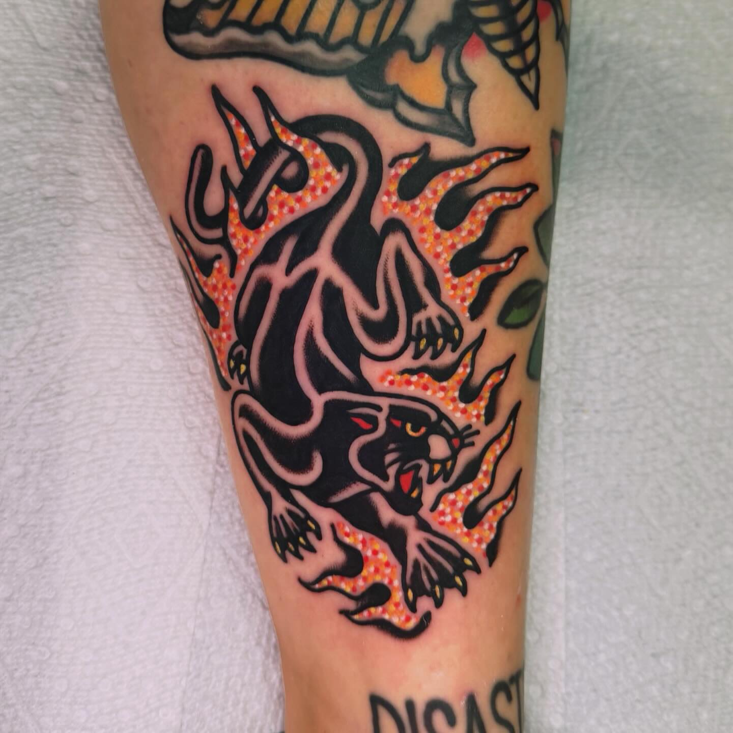 Panther in flames American traditional tattoo on the forearm by Benjamin Ward