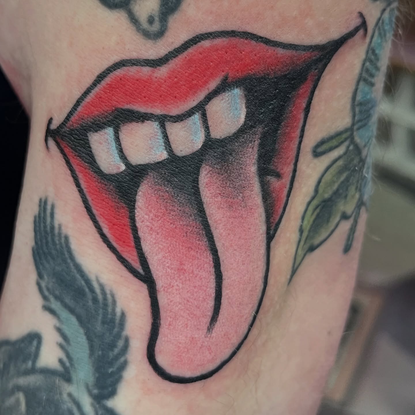 Tongue and teeth American traditional tattoo on the neck by You’ll save me in your phone as Tattoo Tim