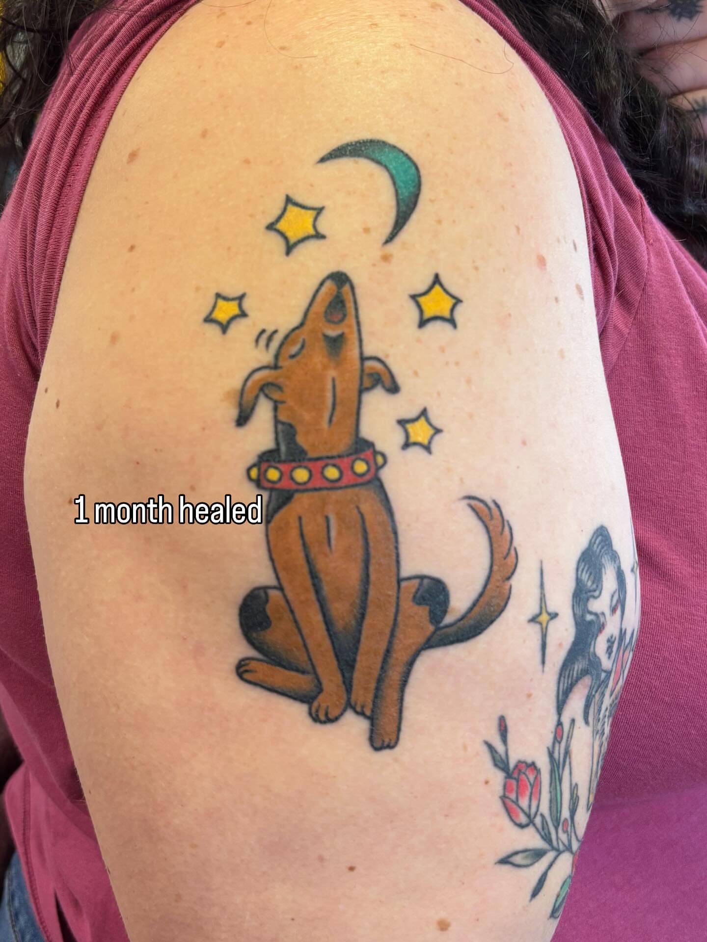 Dog howling at moon American traditional tattoo on the shoulder by Angie Isbell