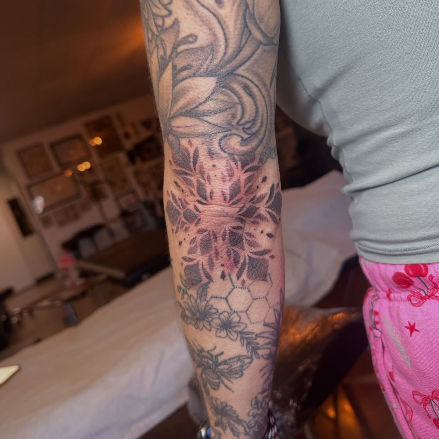 Floral and bee design black and grey tattoo on the forearm by Luisa Gonzalez, Austin, Texas