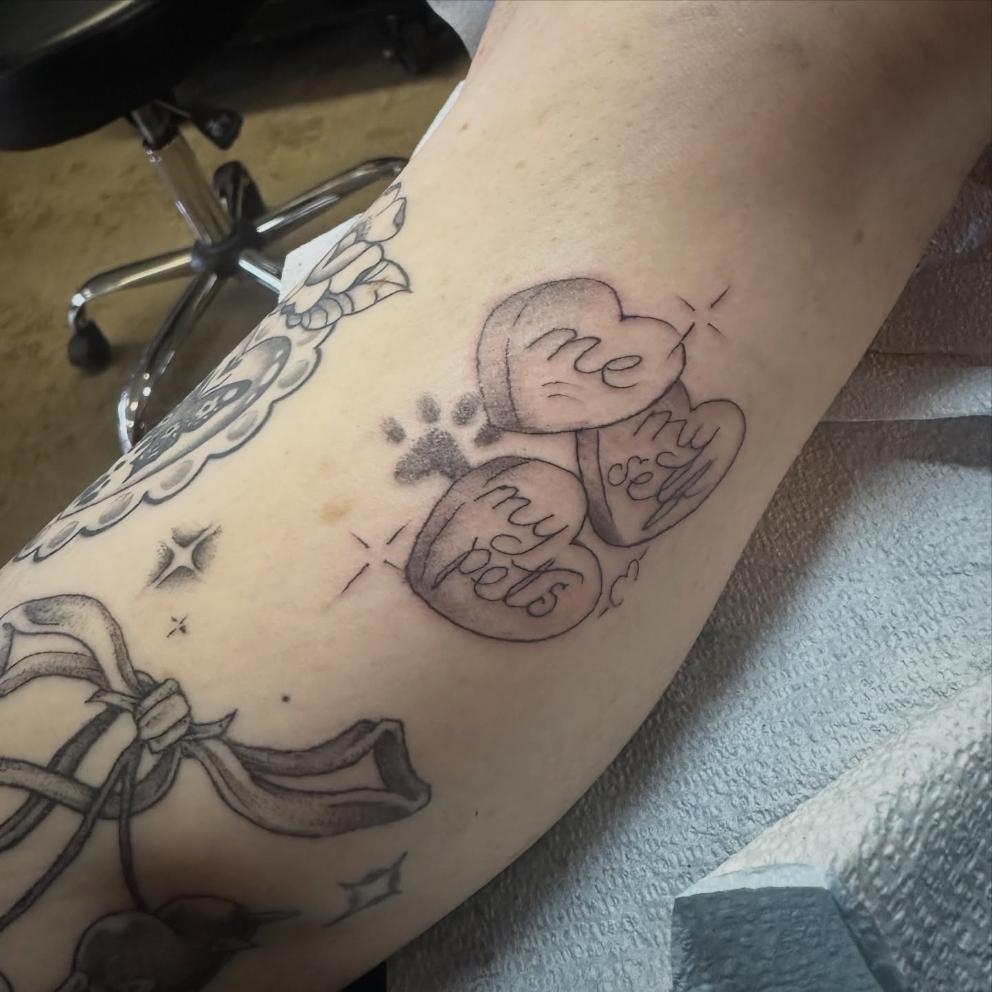 Heart with paw prints black and grey tattoo on the forearm by Luisa Gonzalez, Austin, Texas