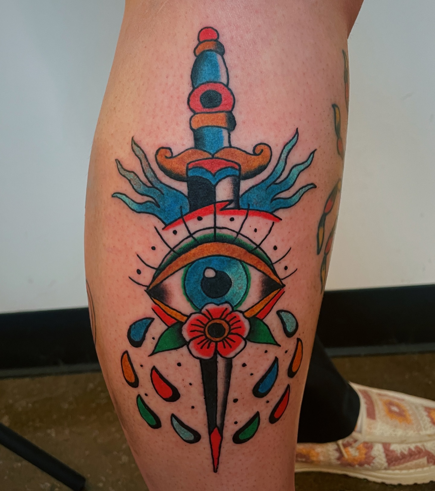 Eye and dagger American traditional tattoo on the leg by Glume Tattoo