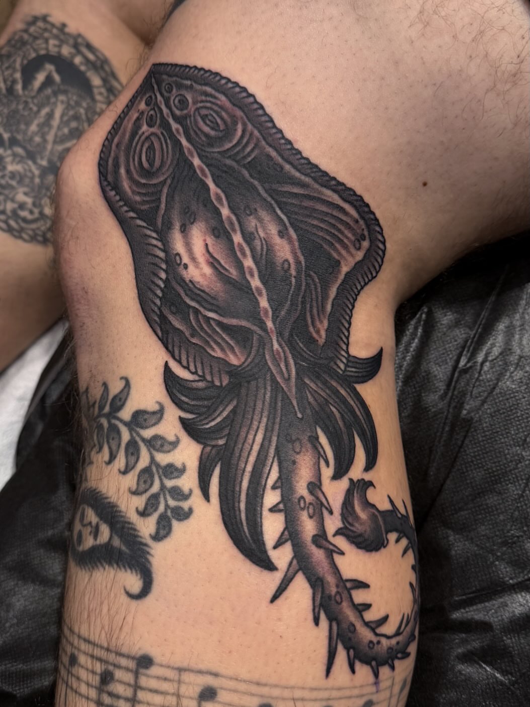 Ray fish black and grey tattoo on the upper arm by Laurent Trelaun, San Francisco, California