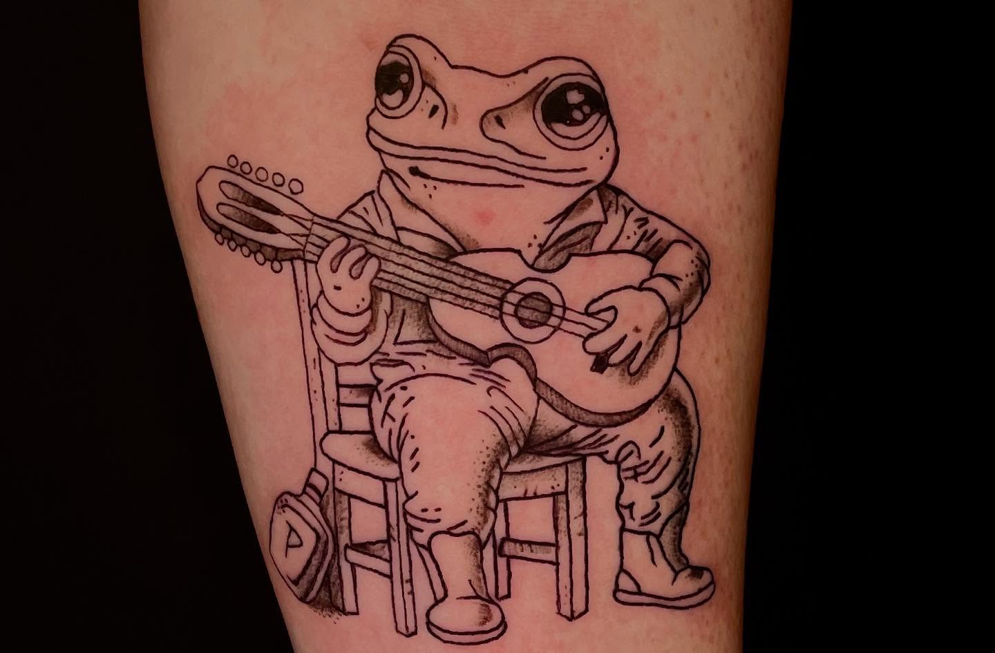 Frog playing guitar black and grey tattoo on the forearm by ๐ท๐ซKevan๐๐ท