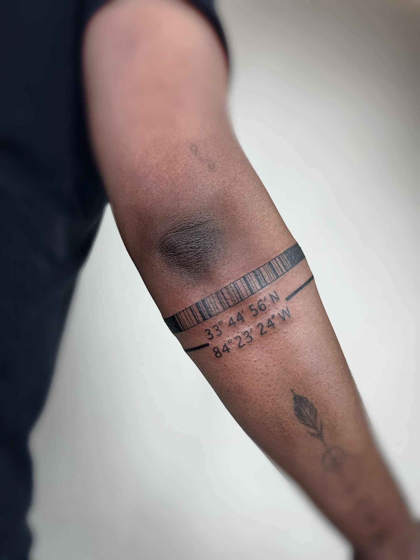 Coordinates black and grey tattoo on the forearm by Jadyn Pang