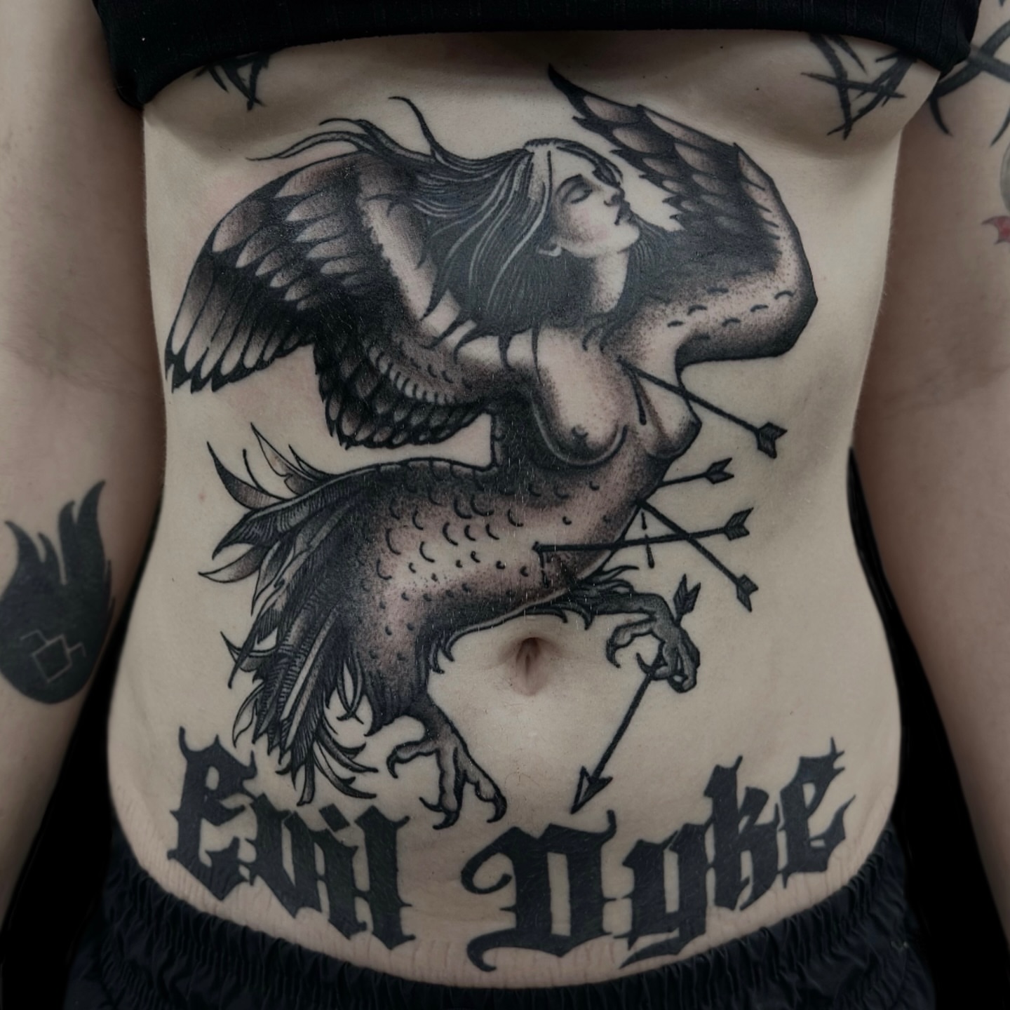 Mermaid and crow black and grey tattoo on the torso by Madeline Brown