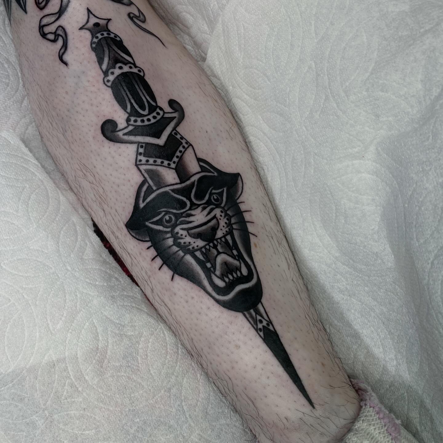 Panther and dagger black and grey tattoo on the forearm by Lindsey Cam Van