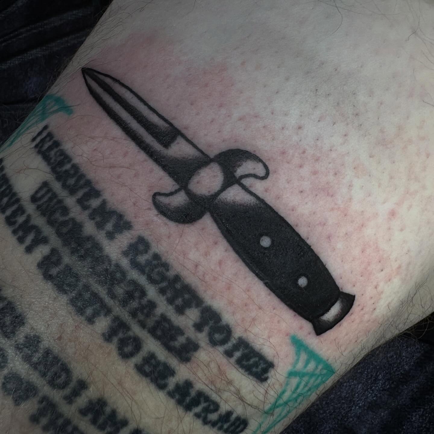 Knife black and grey tattoo on the forearm by Lindsey Cam Van