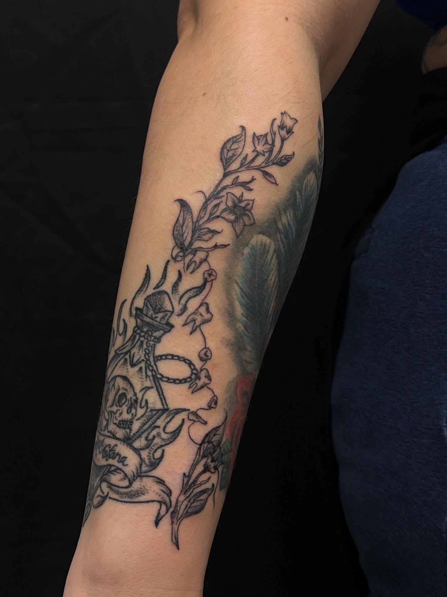 Anchor and flowers American traditional tattoo on the forearm by cortez