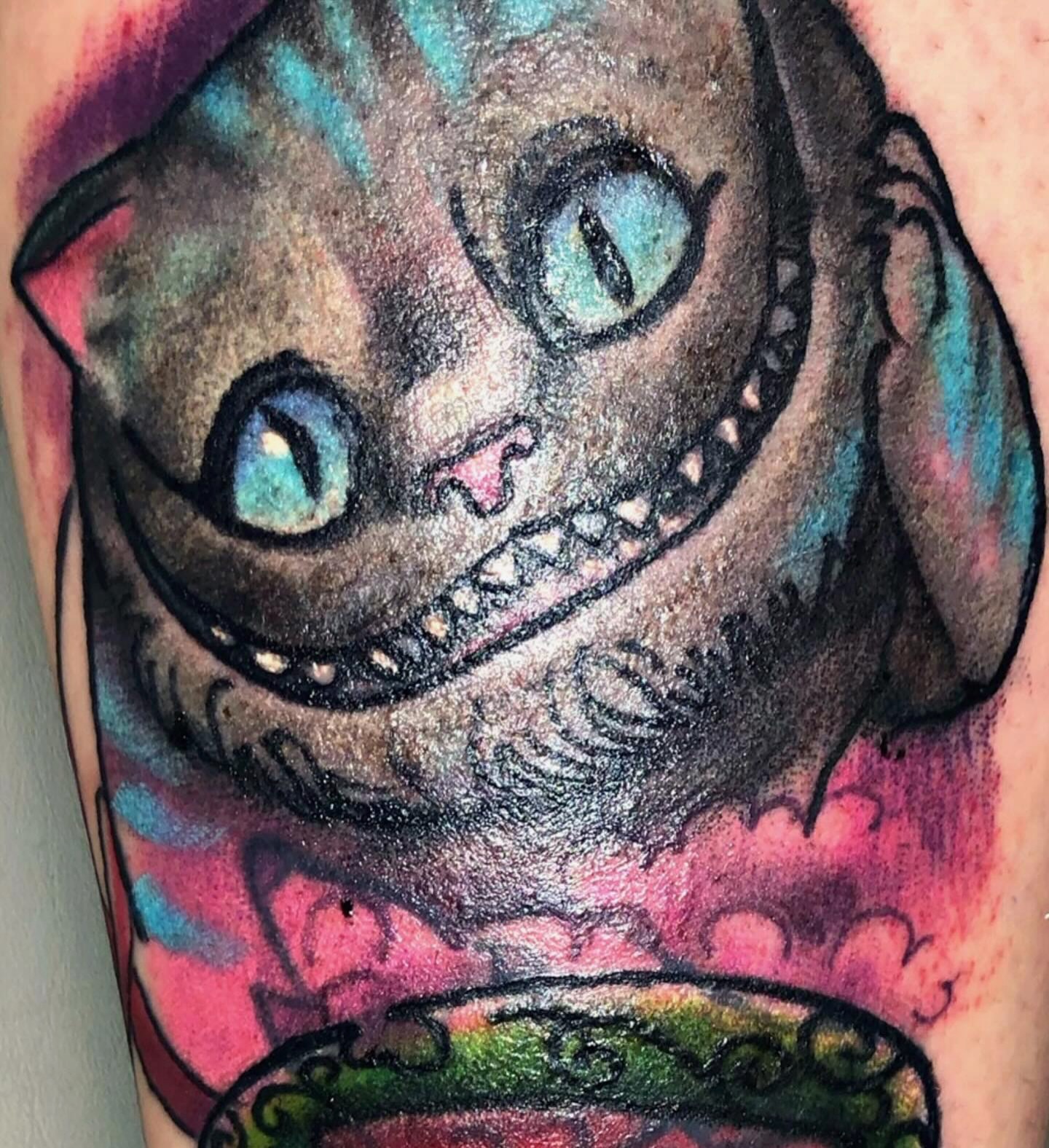 Cheshire cat American traditional tattoo on the forearm by @juiceinkythings