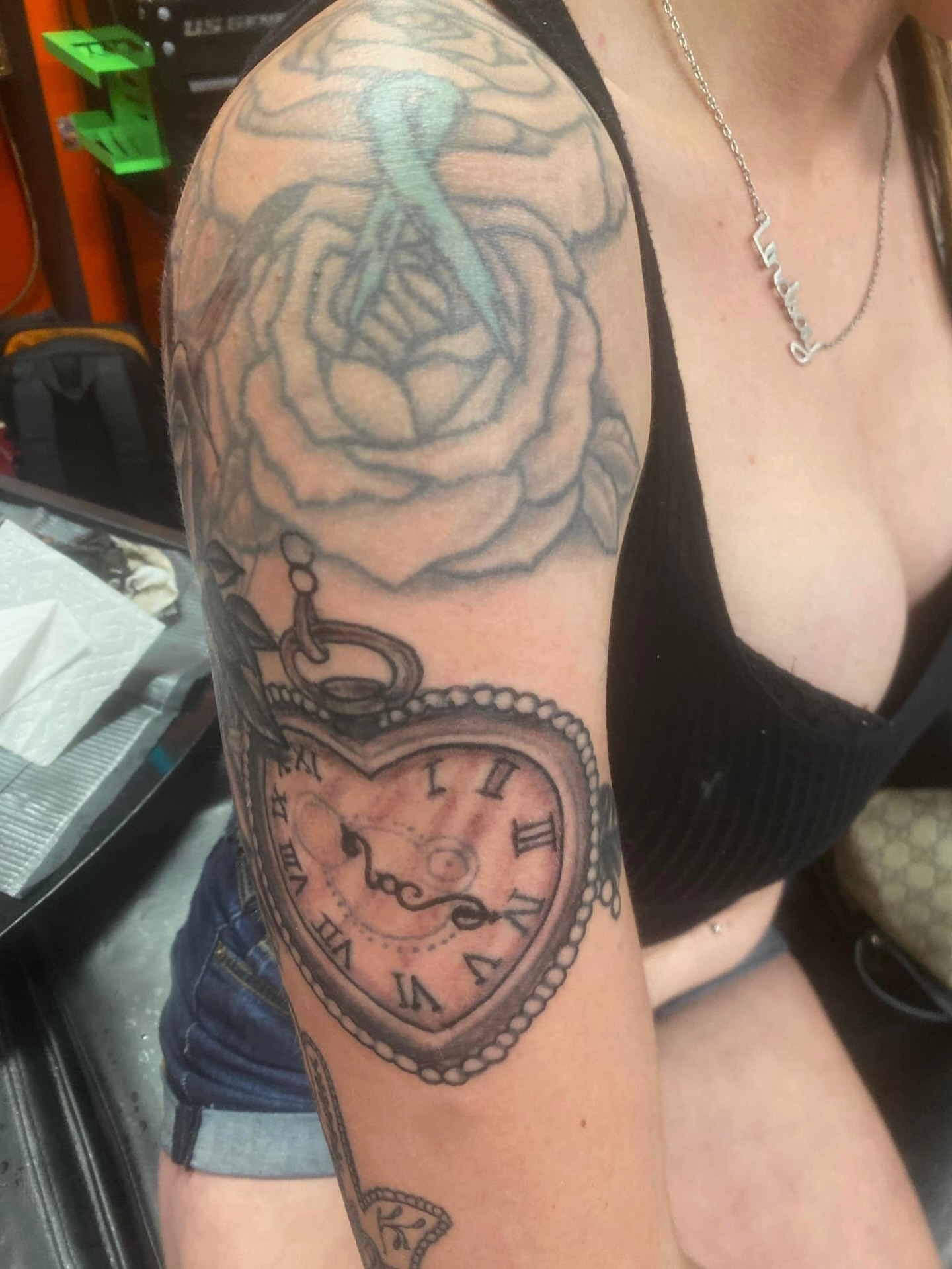 Heart-shaped pocket watch black and grey tattoo on the forearm by @juiceinkythings
