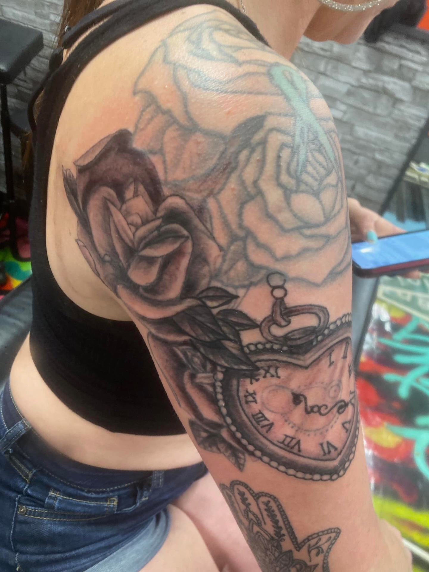 Rose and pocket watch realism tattoo on the upper arm by @juiceinkythings