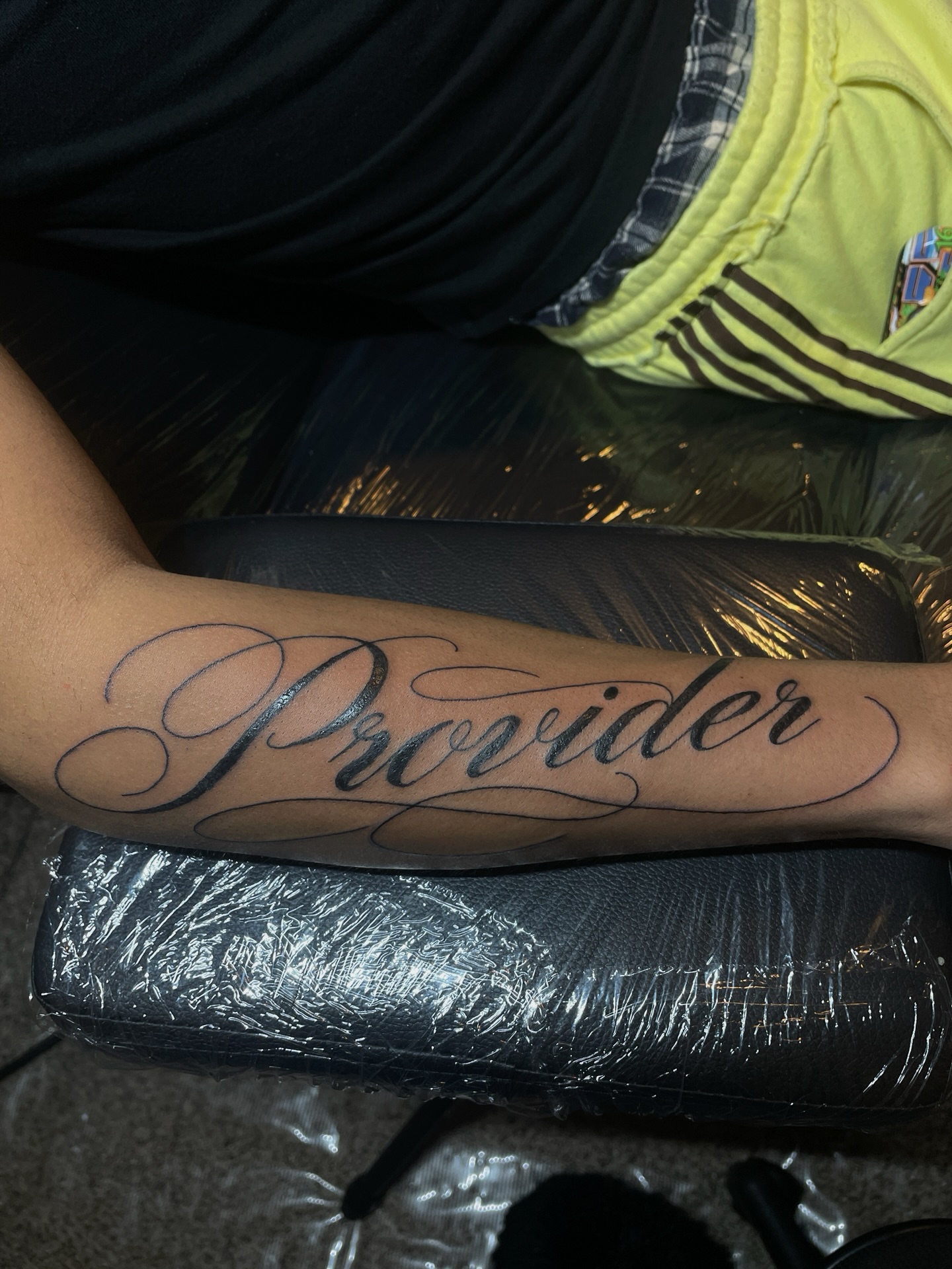 Provider lettering script tattoo on the forearm by ɴᴏᴍᴢ ᴅʏsᴇᴍʙᴏᴅɪᴍᴇɴᴛ