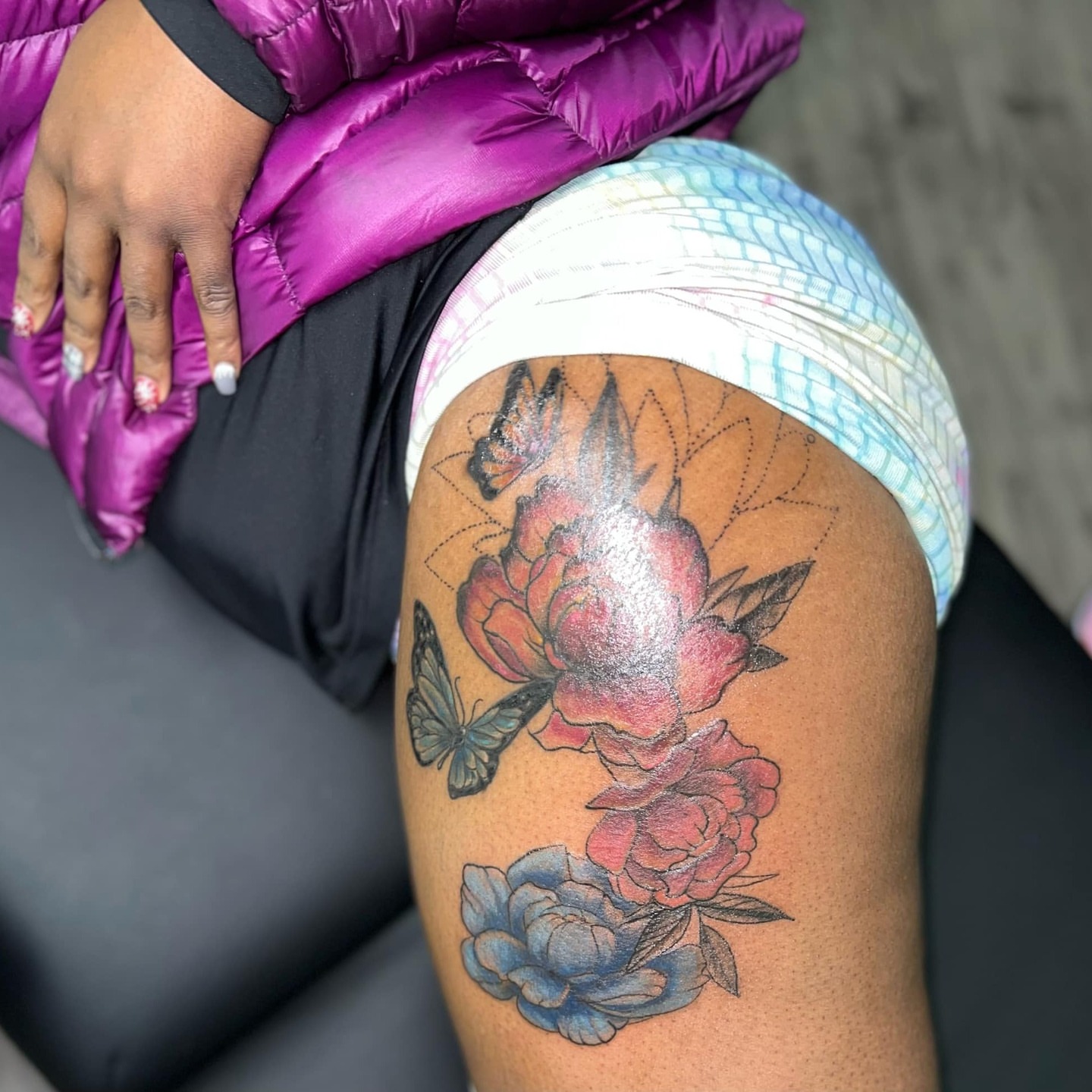 Flowers and butterfly new school tattoo on the thigh by @juiceinkythings