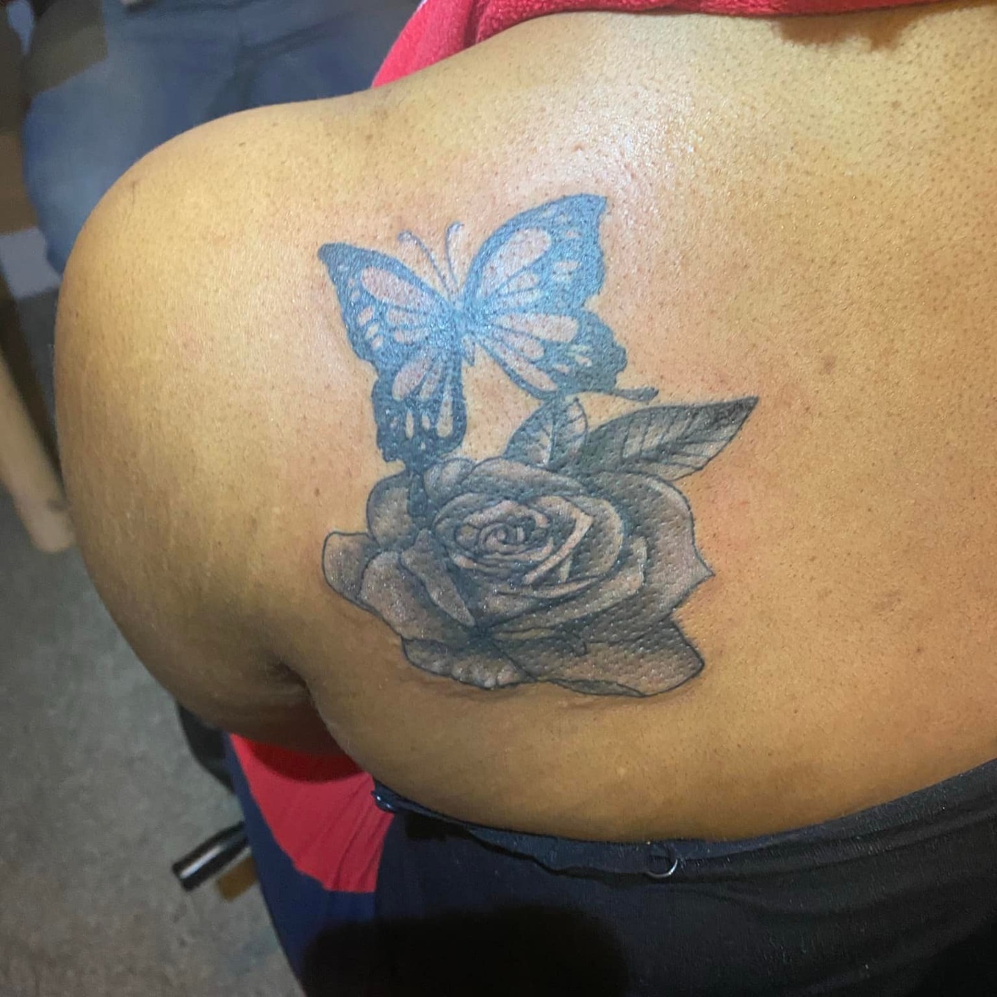 Rose and butterfly black and grey tattoo on the back by @juiceinkythings
