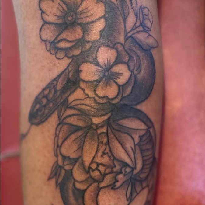 Flower black and grey tattoo on the forearm by @juiceinkythings
