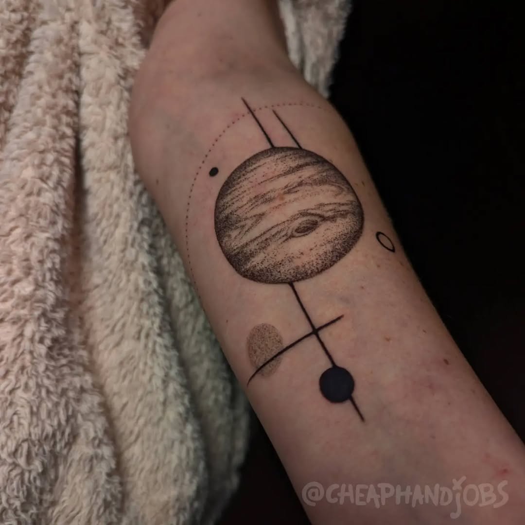 Planet with geometric elements ignorant tattoo on the forearm by @cheaphandjobs, Leipzig, Germany