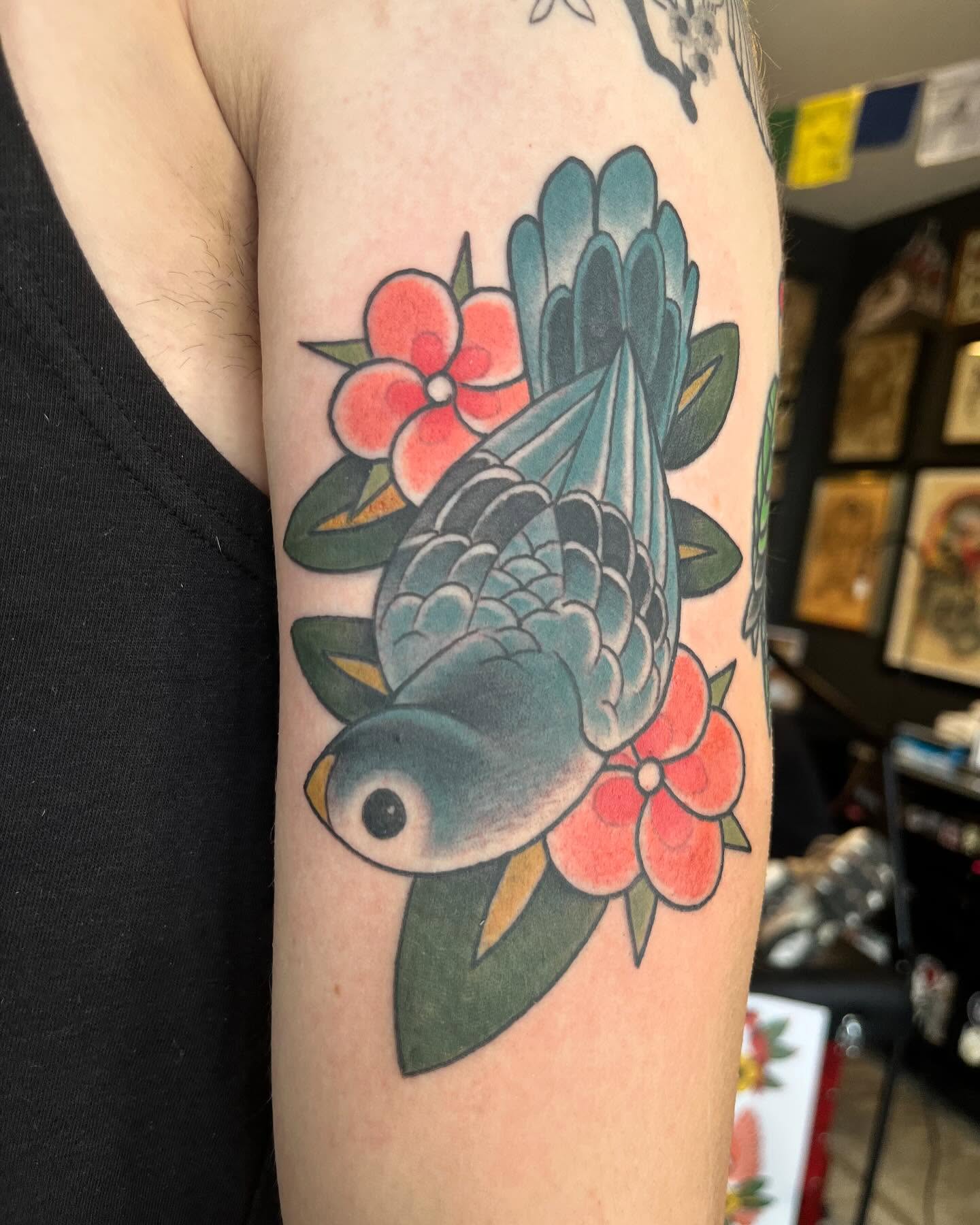 Bird and flowers American traditional tattoo on the forearm by Ian White