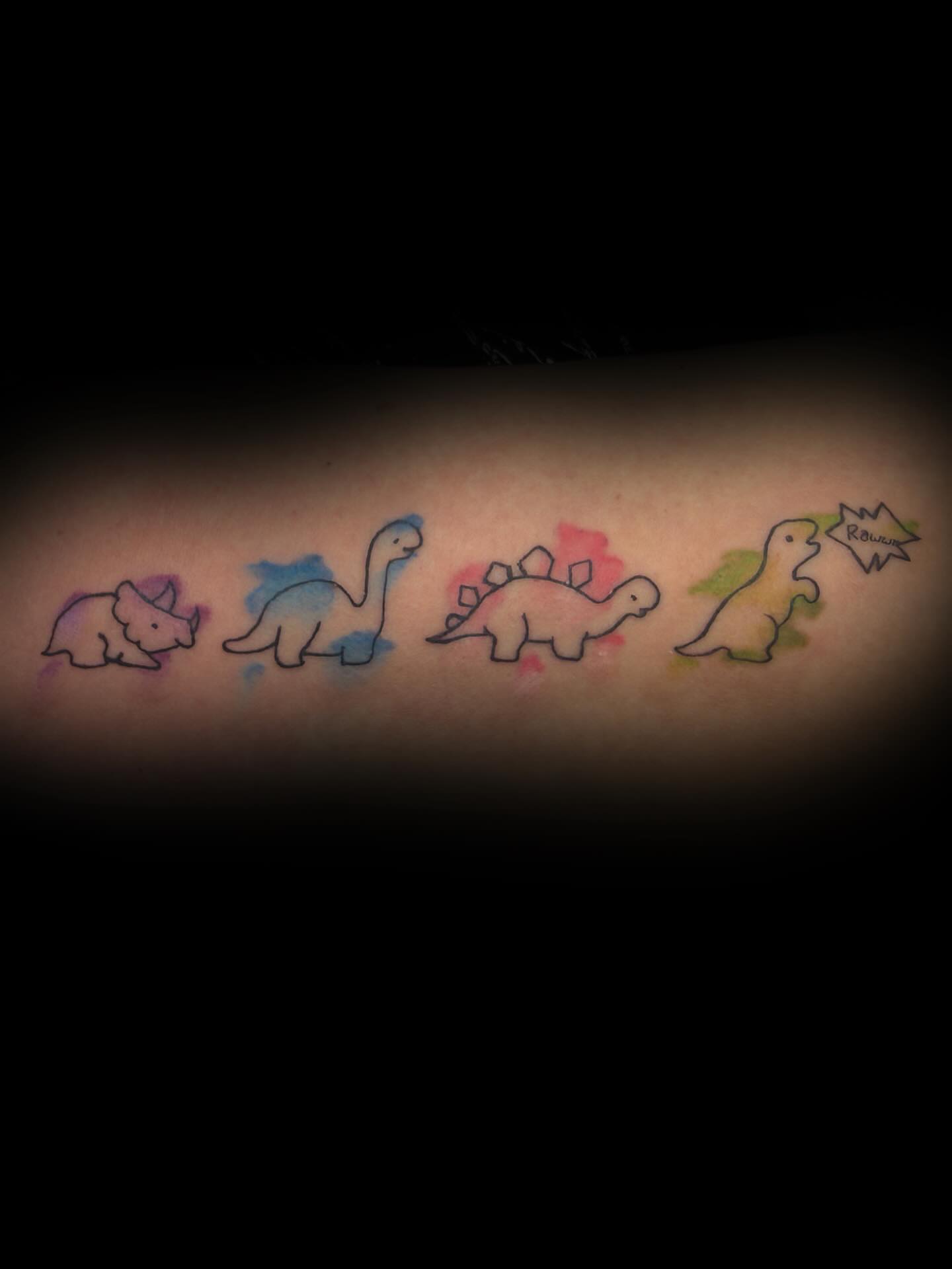 Dinosaur quartet watercolor tattoo on the forearm by sᴋᴇᴛᴄʜᴇᴅ