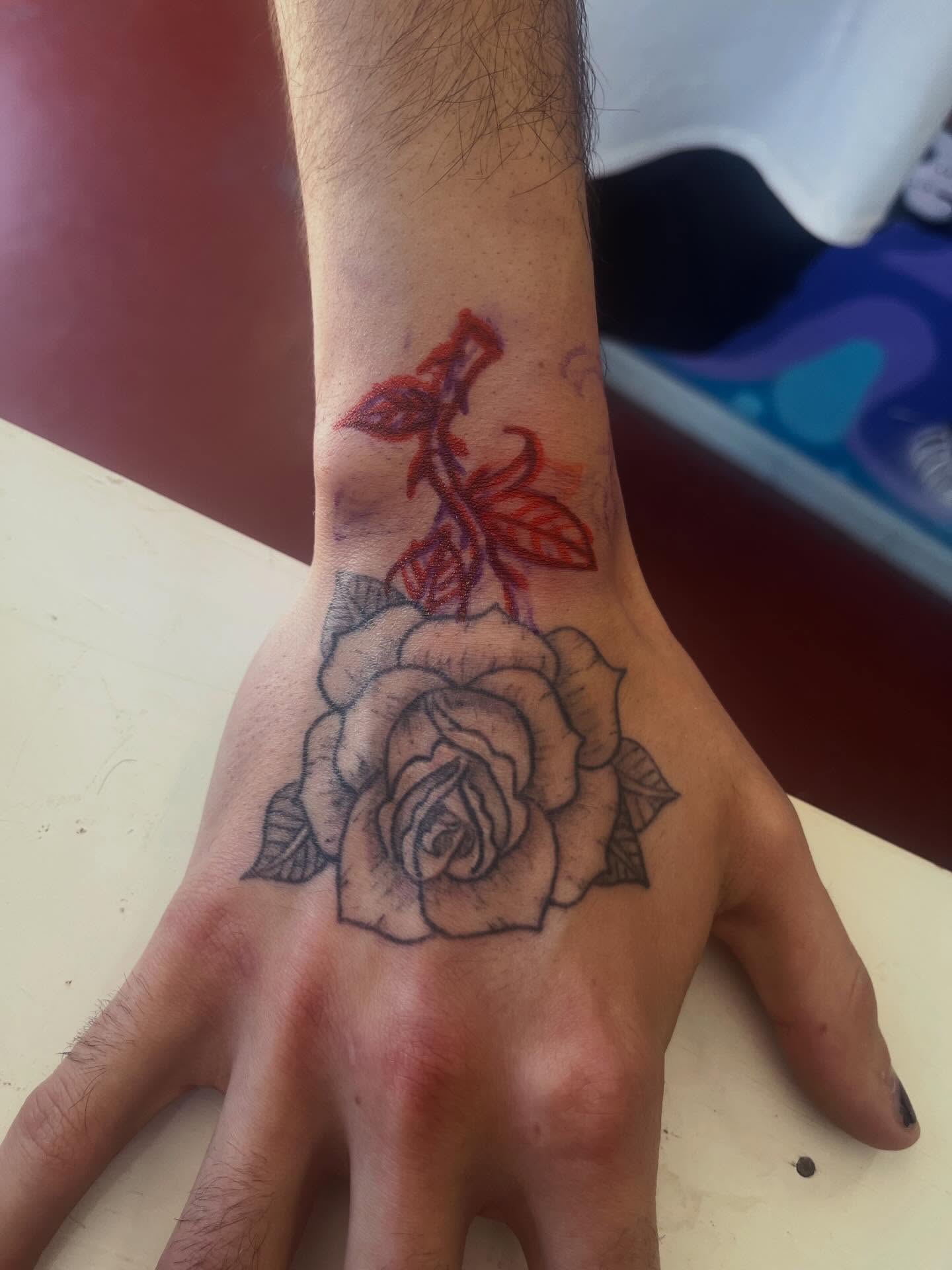 Rose black and grey tattoo on the hand by Rafaela Lopez