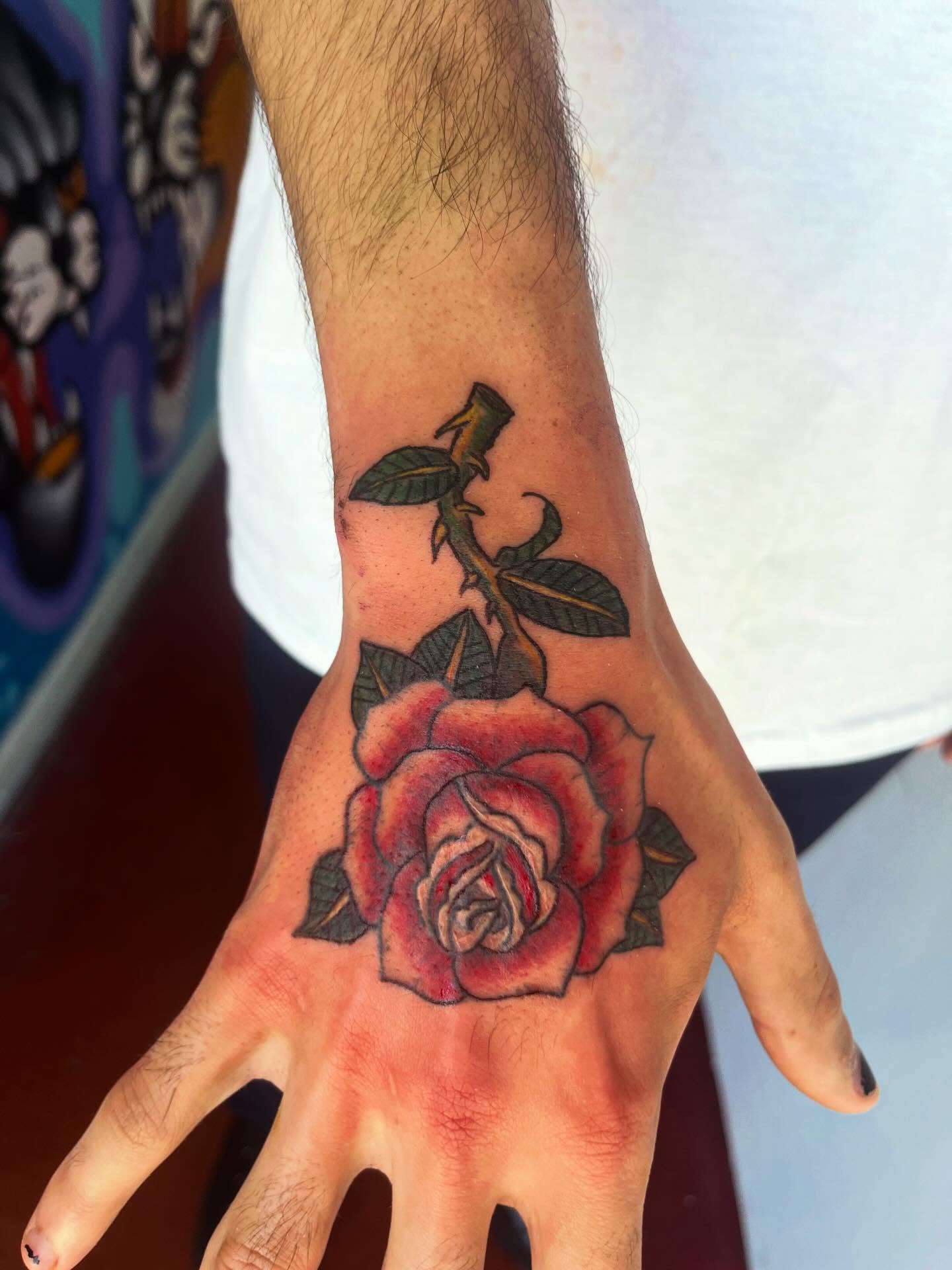 Rose American traditional tattoo on the hand by Rafaela Lopez
