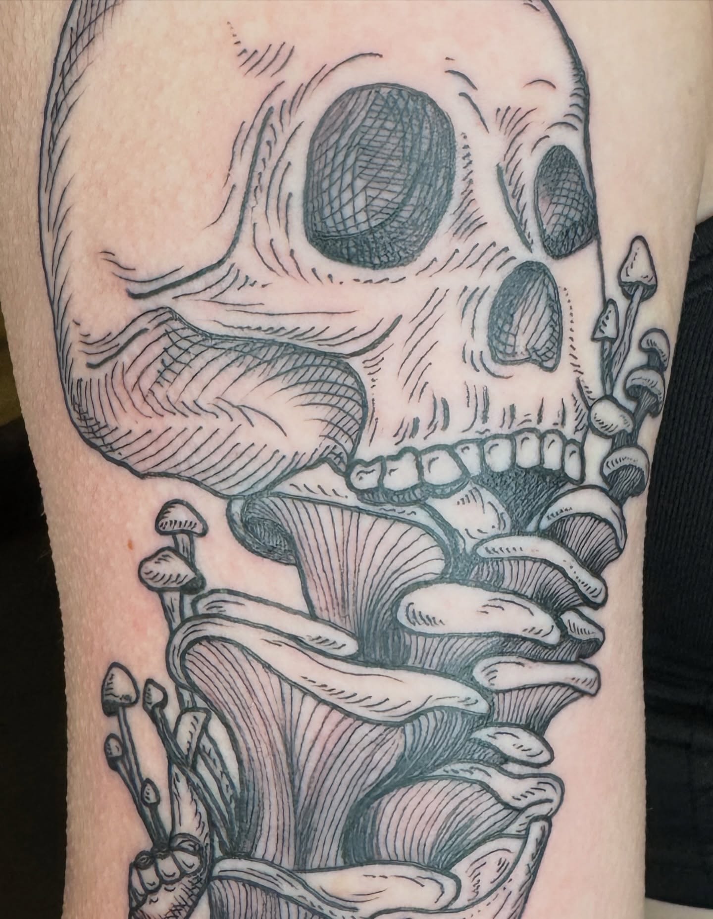 Skull and mushrooms realism tattoo on the forearm by Lora Bird