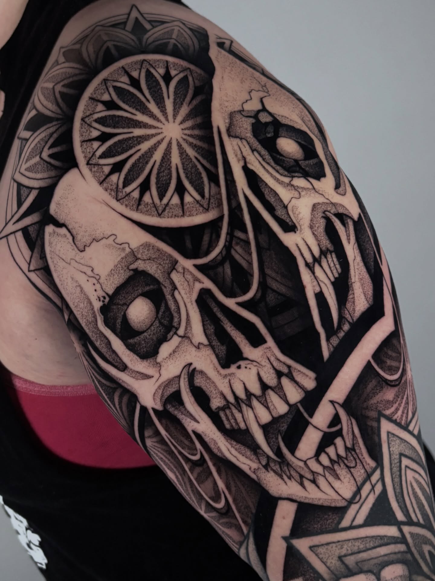 Skull and mandala dotwork tattoo on the shoulder by Mitch Koch