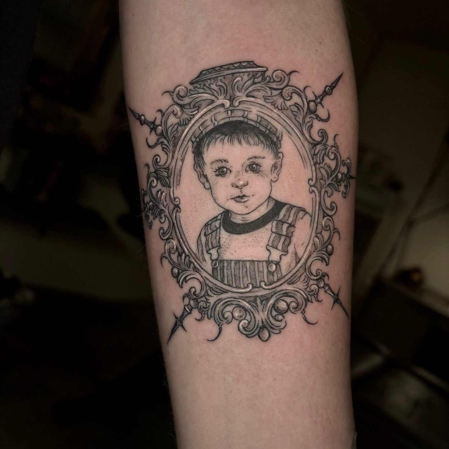 Child portrait realism tattoo on the forearm by Quin Walker