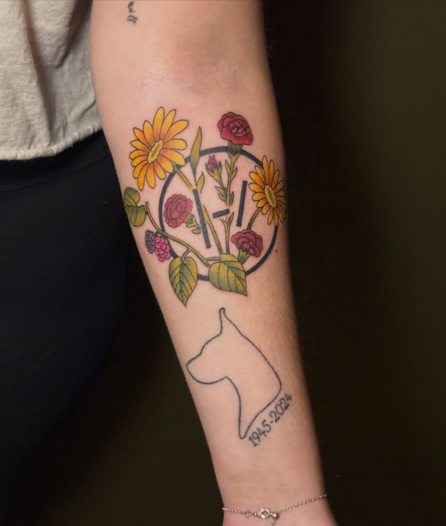 Dog silhouette with flowers new school tattoo on the forearm by Whimsical illustrative