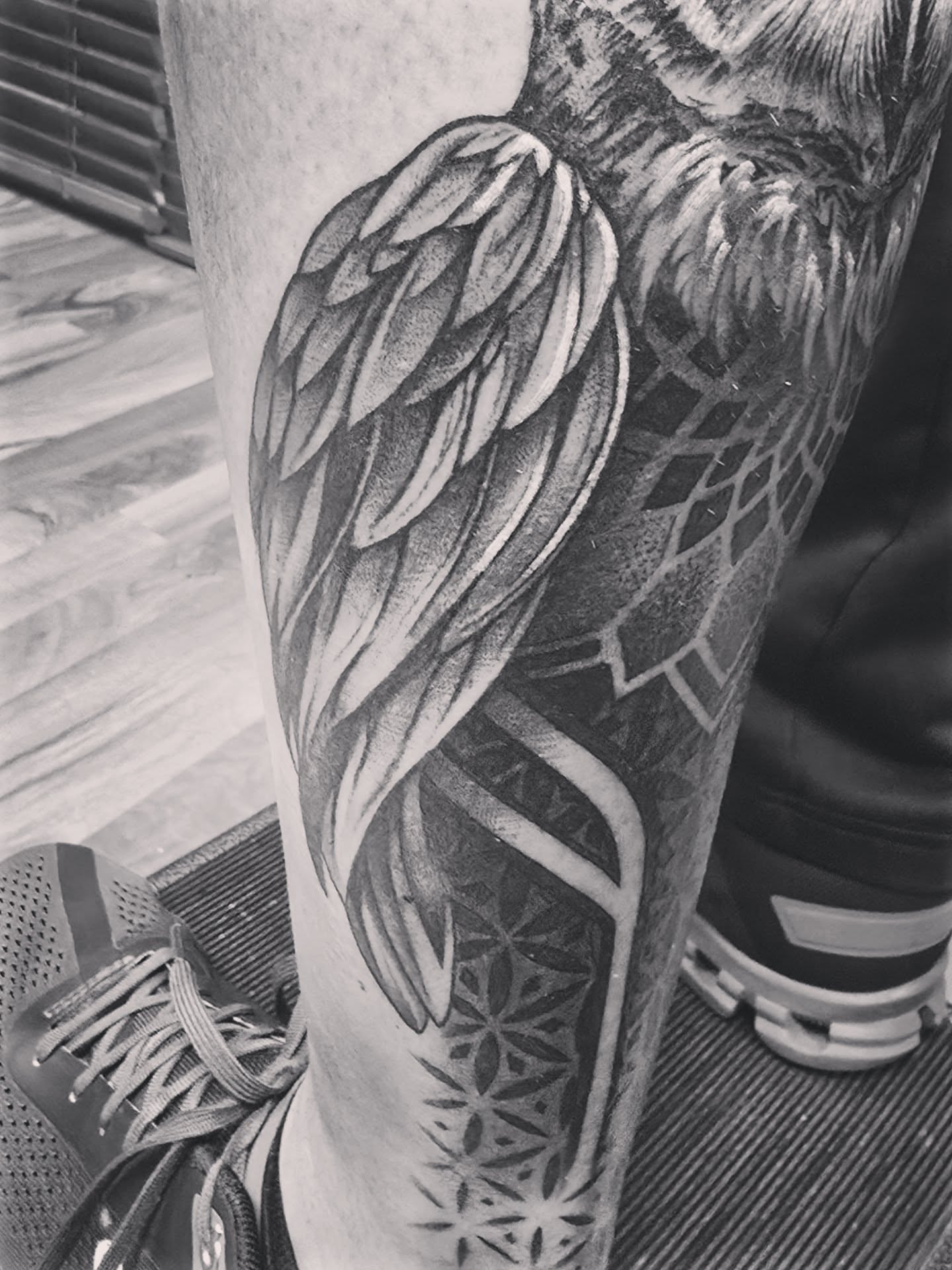 Wing geometric tattoo on the calf by Alexander L. Wolff, Rapid City, South Dakota